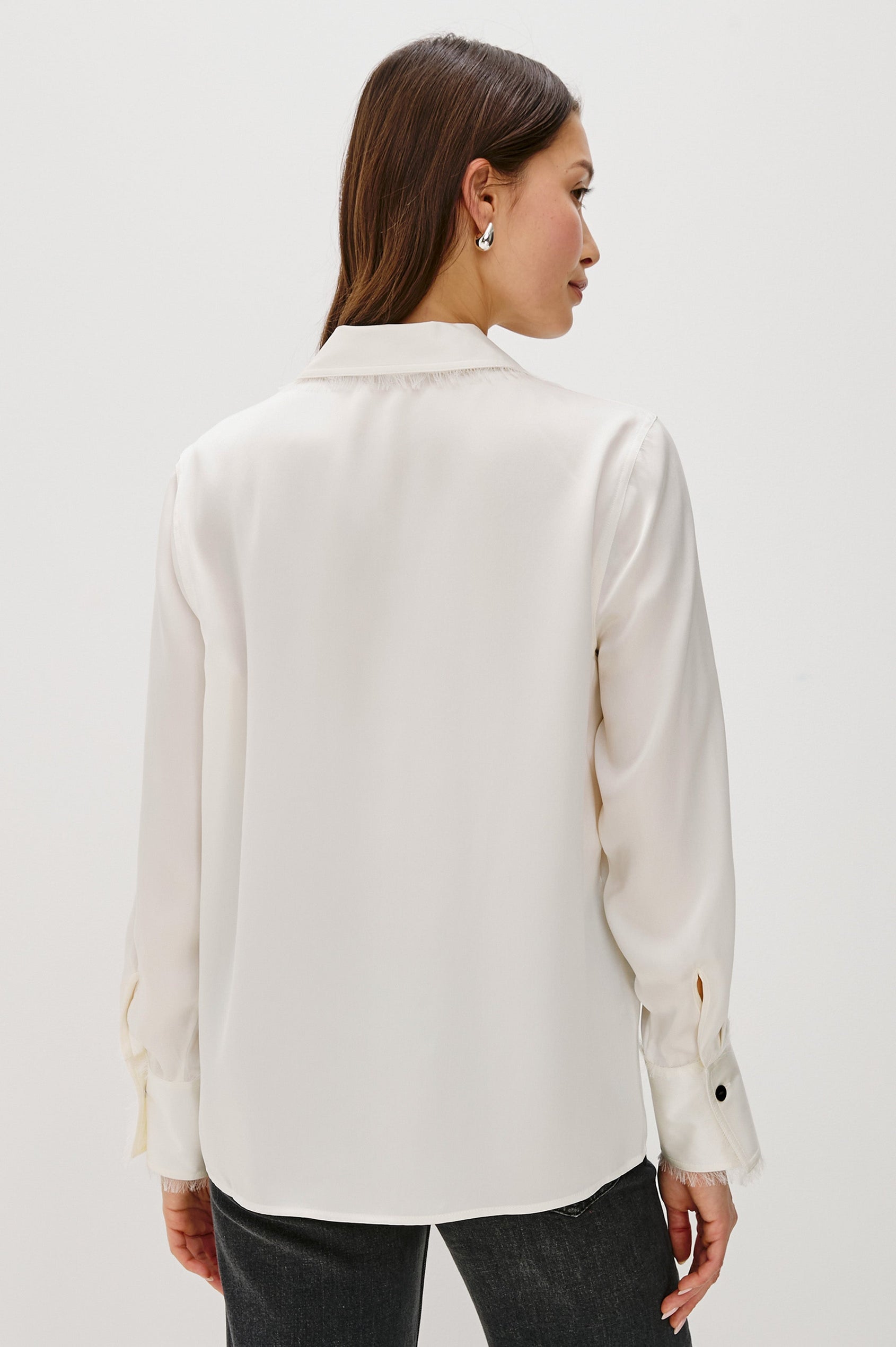 Abbey silk long sleeve button-down shirt with a raw edge trim at the collar and sleeve cuffs in Ivory colorway - back view on model