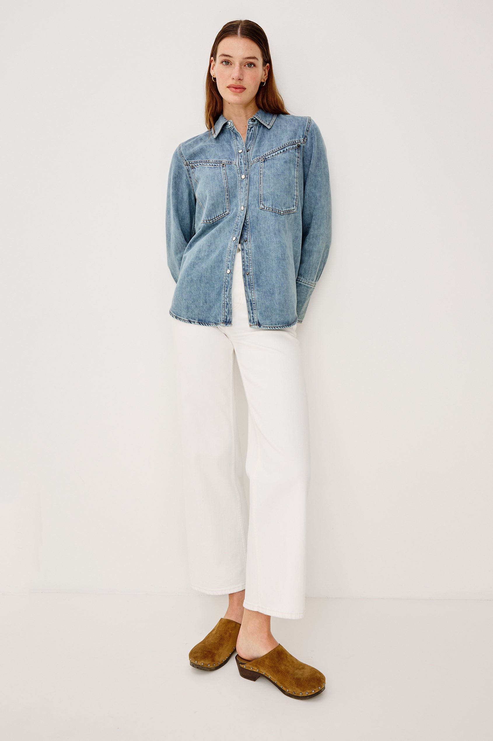 Acton Shirt in Cotton Lyocell Denim With Collar Front Snap Buttons Front and Back Yokes Gunmetal Snap Detailing and Long Sleeves in Wester Blue Colorway - Full Body Front View Featured on Model