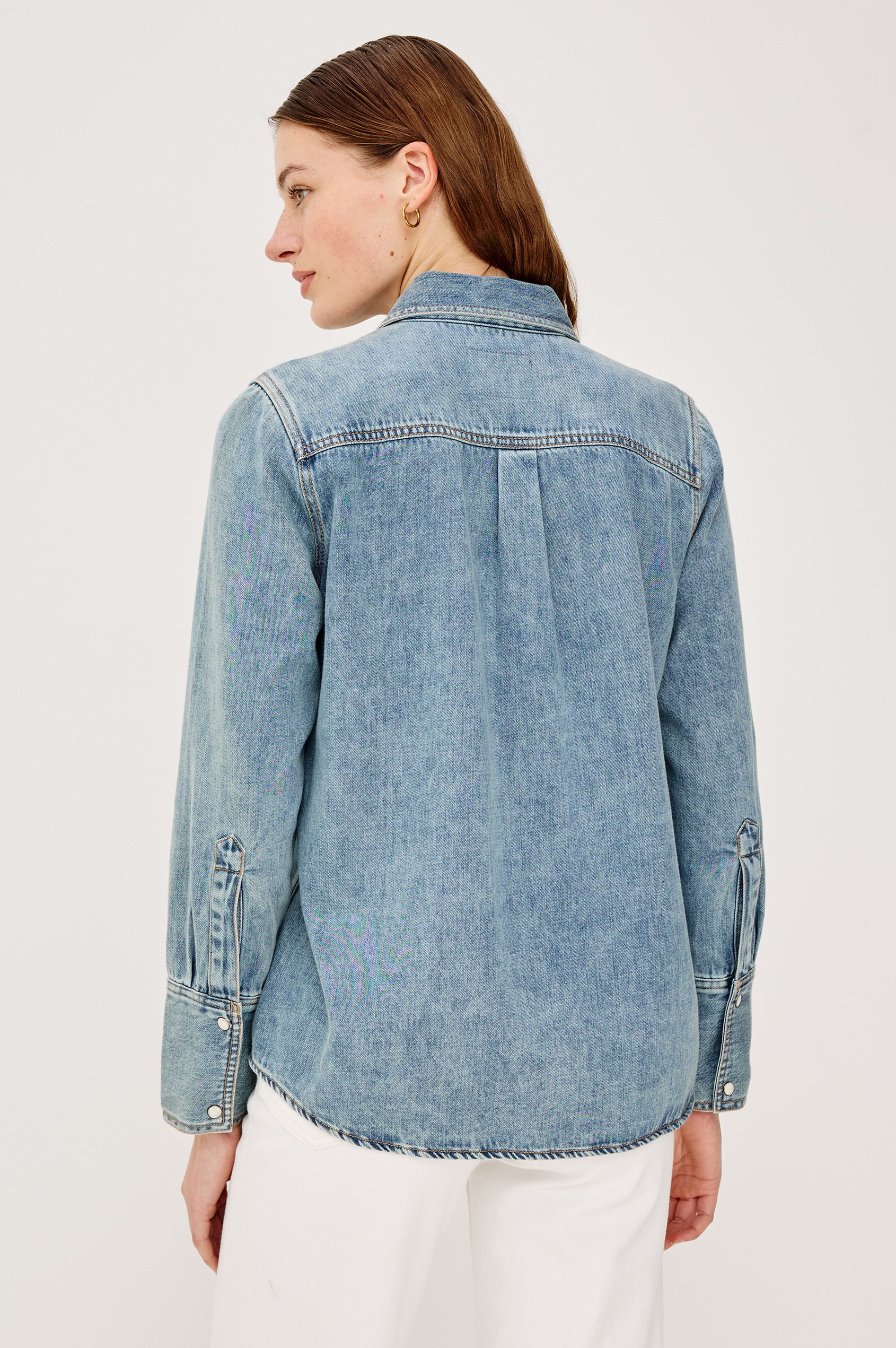 Acton Shirt in Cotton Lyocell Denim With Collar Front Snap Buttons Front and Back Yokes Gunmetal Snap Detailing and Long Sleeves in Wester Blue Colorway - Upper Body Back View Featured on Model
