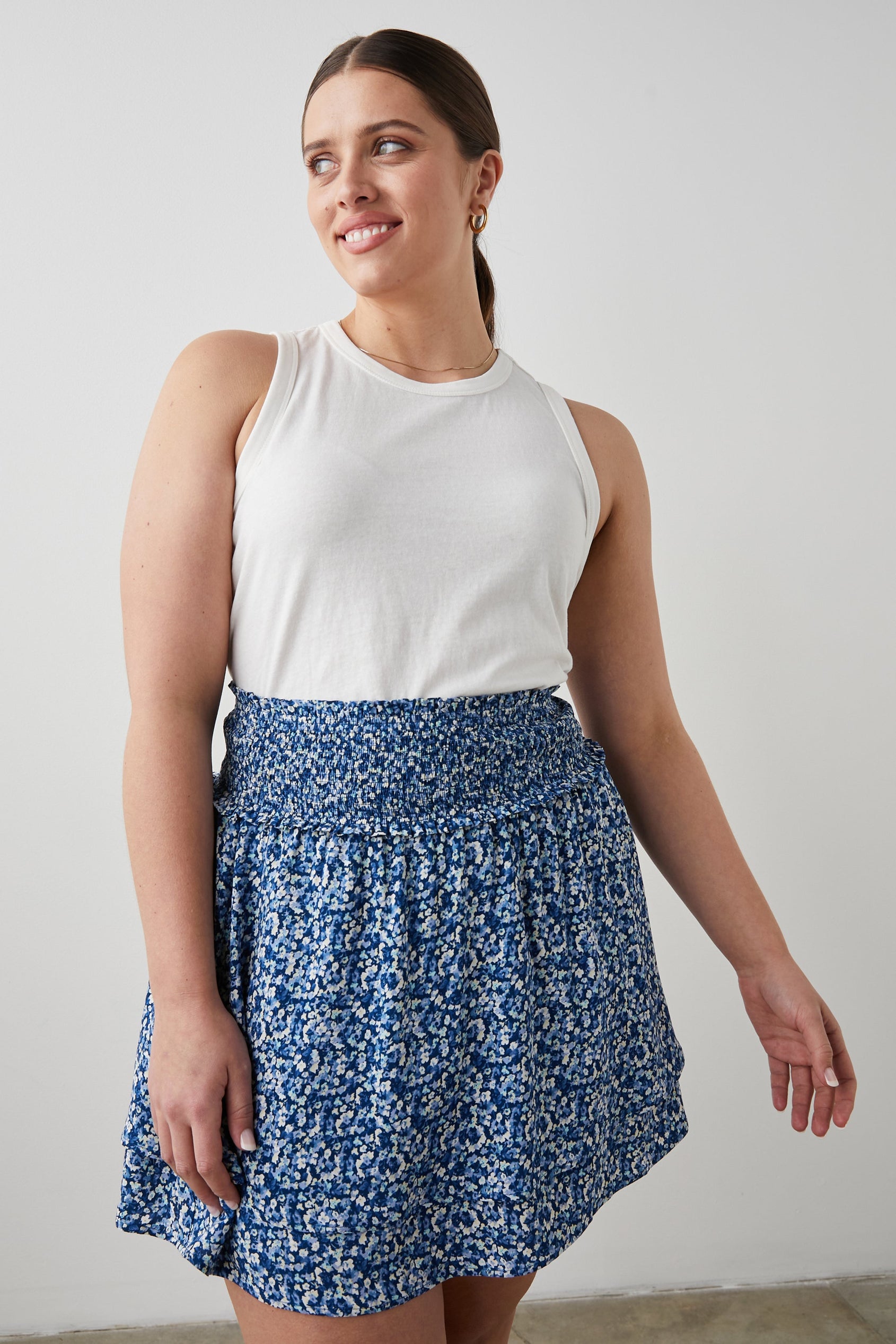 Addison Mini Skirt with a Smocked Waist and a Shorter Over Layer in Ice Chrysanthemum Colorway, Abstract Floral in White and Blues - Front View Featured on Model