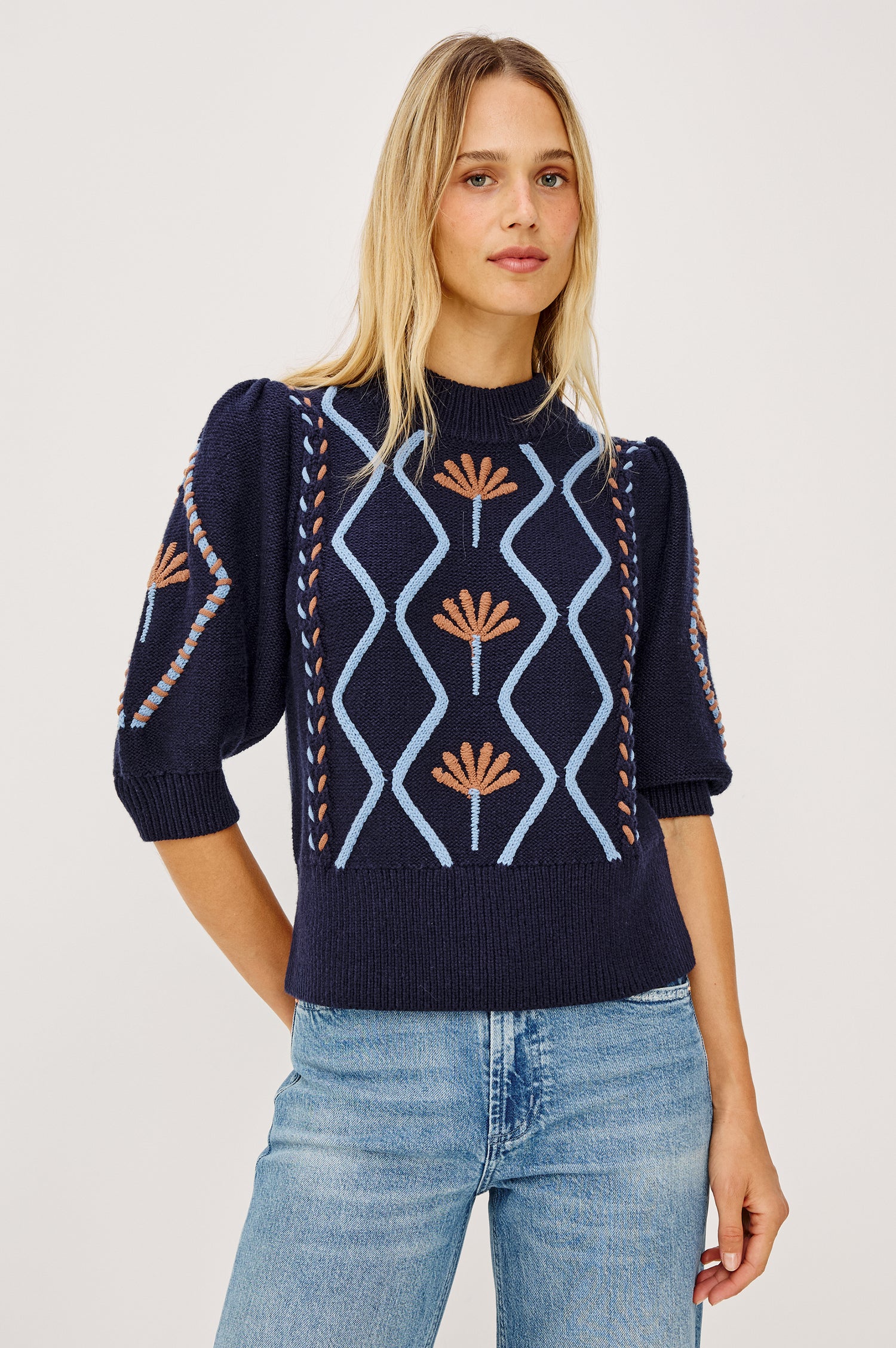 Addy Sweater in Cable Knit With Mock Neck, Relaxed Fit, and Elbow-Length Puff Sleeves in Floral Cables - Upper Body Front View Featured on Model