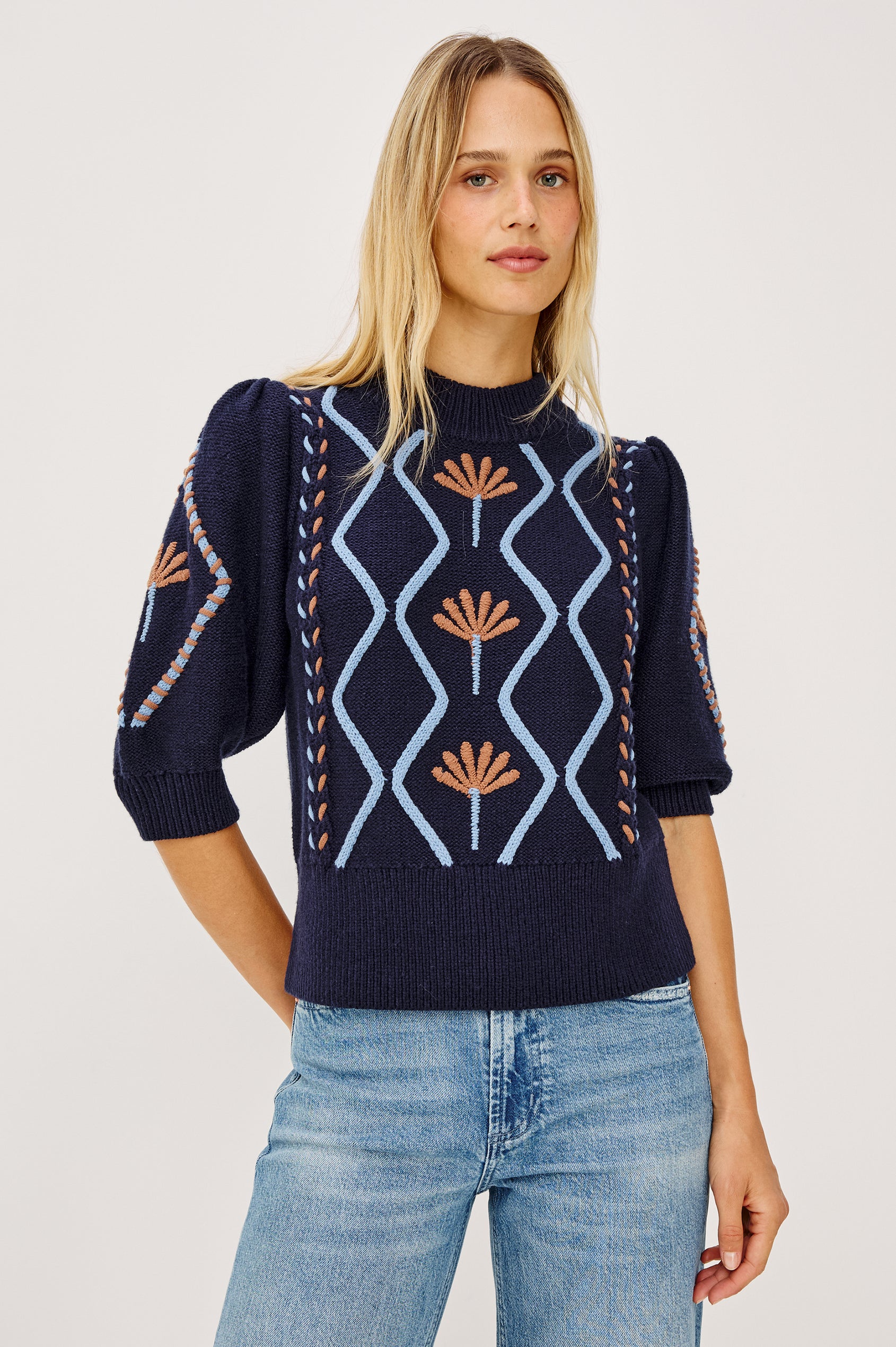 Addy Sweater in Cable Knit With Mock Neck, Relaxed Fit, and Elbow-Length Puff Sleeves in Floral Cables - Upper Body Front View Featured on Model