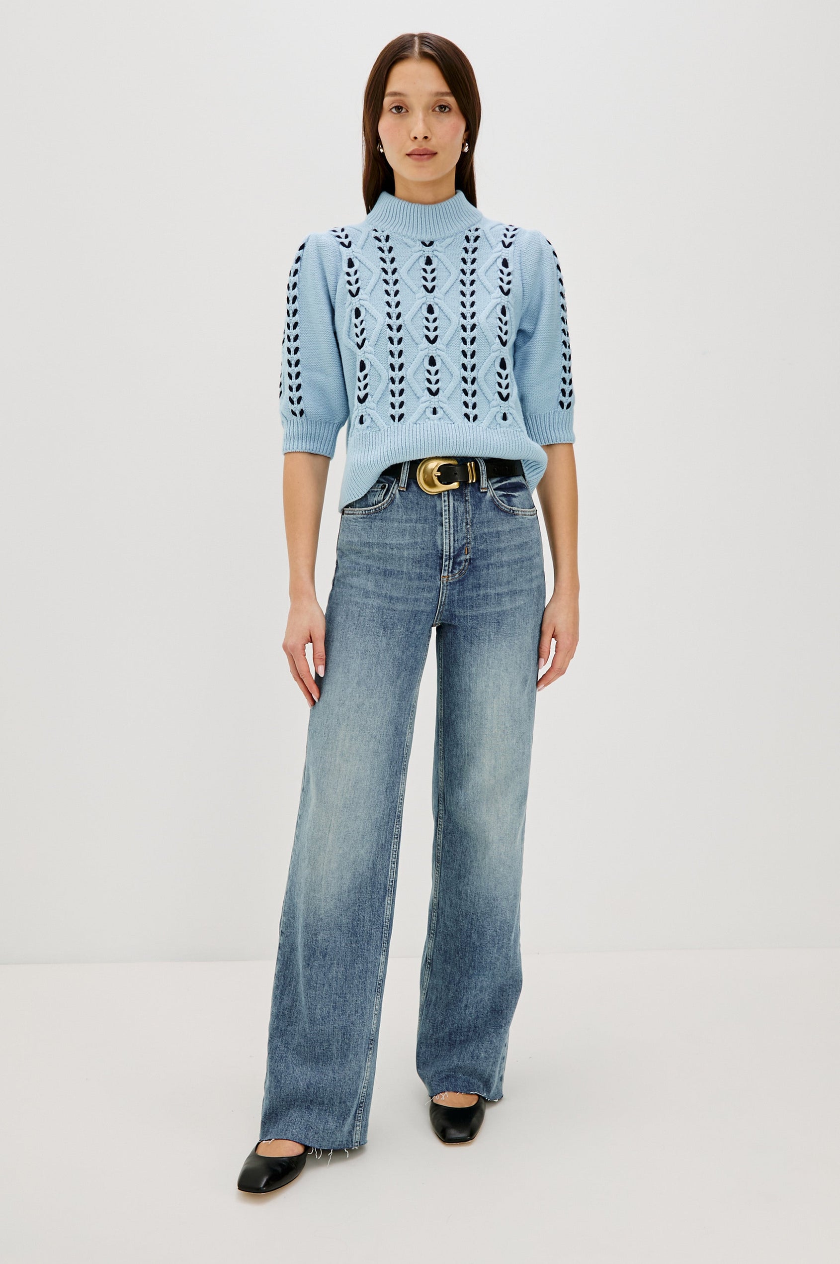 Addy Three Quarter Sleeve Sweater with Contrast Cable Knit Stitching and Ribbing at the Neck, Armhole, and Bottom Hem in Sky Navy Cables Colorway -  Full body front view on model