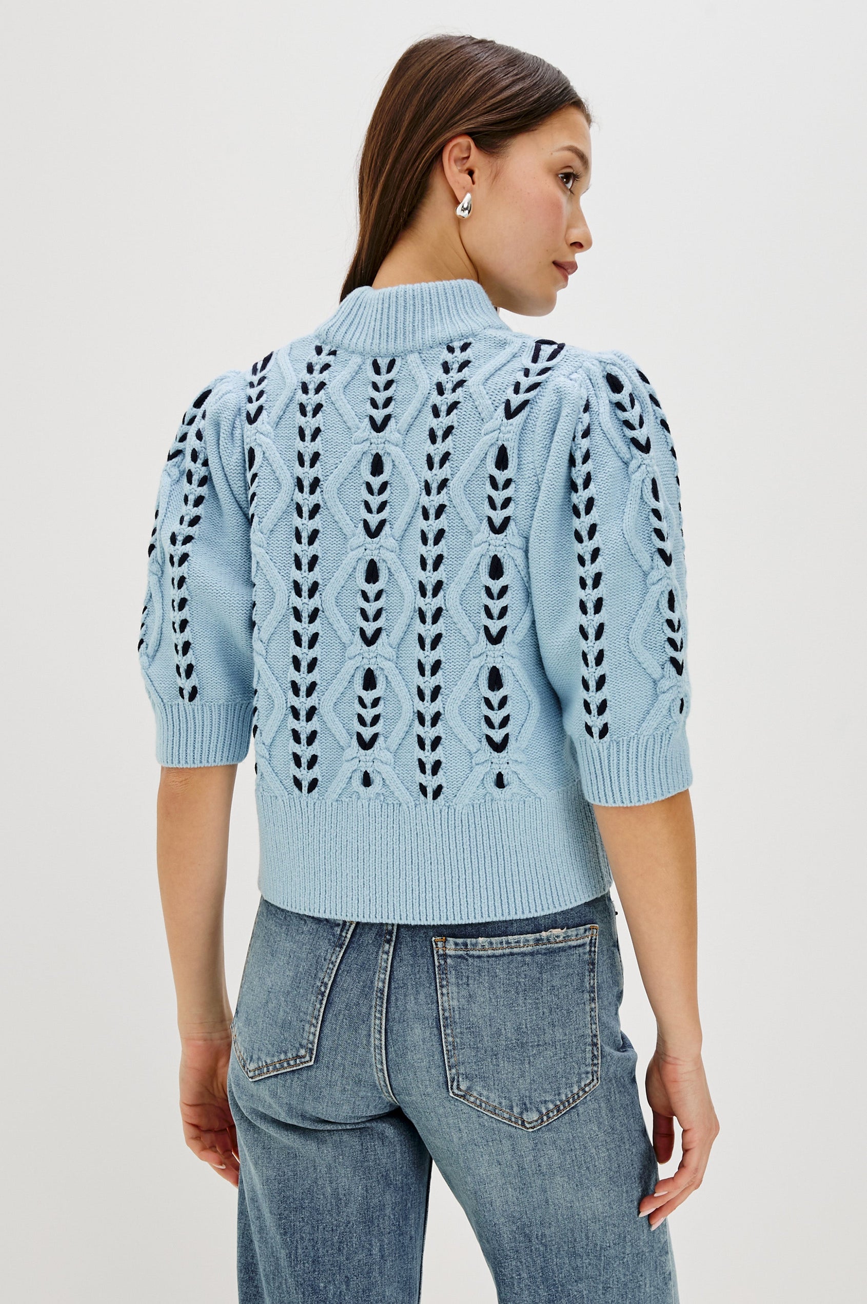 Addy Three Quarter Sleeve Sweater with Contrast Cable Knit Stitching and Ribbing at the Neck, Armhole, and Bottom Hem in Sky Navy Cables Colorway - Back view on model