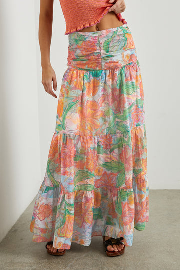 Agatha Maxi Tiered Skirt with Ruching at the Waist in Tropics Colorway, Flowers in Oranges, Pinks and Greens on White - Front View Featured on Model  