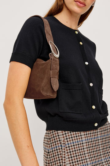 Aisley, a short-sleeve cotton-cashmere sweater with a semi-fitted silhouette. The sweater features a round neckline and is accented with a row of elegant pearl buttons down the front. Close Up View on Model