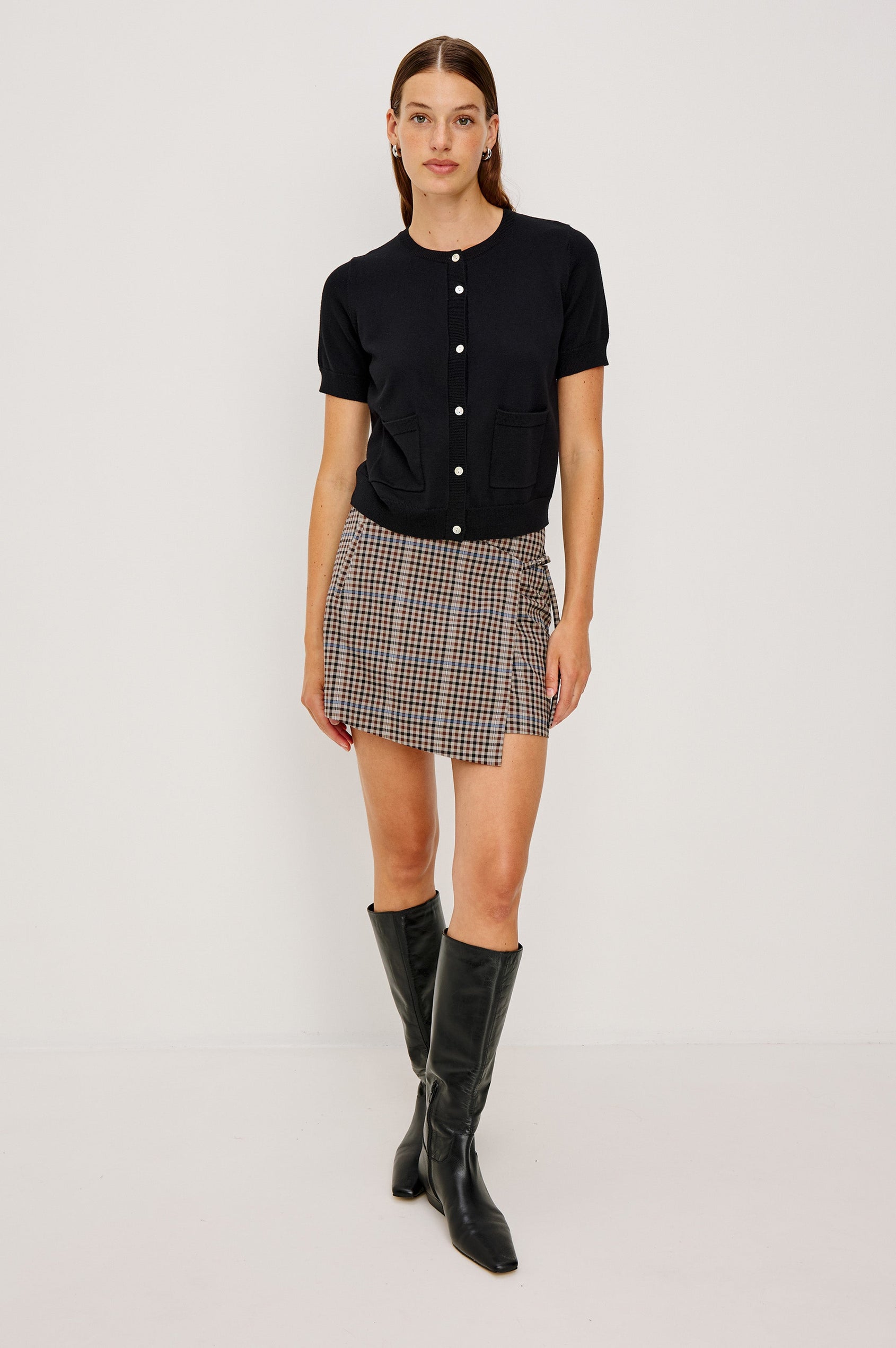 Aisley, a short-sleeve cotton-cashmere sweater with a semi-fitted silhouette. The sweater features a round neckline and is accented with a row of elegant pearl buttons down the front. Full Body Front View on Model