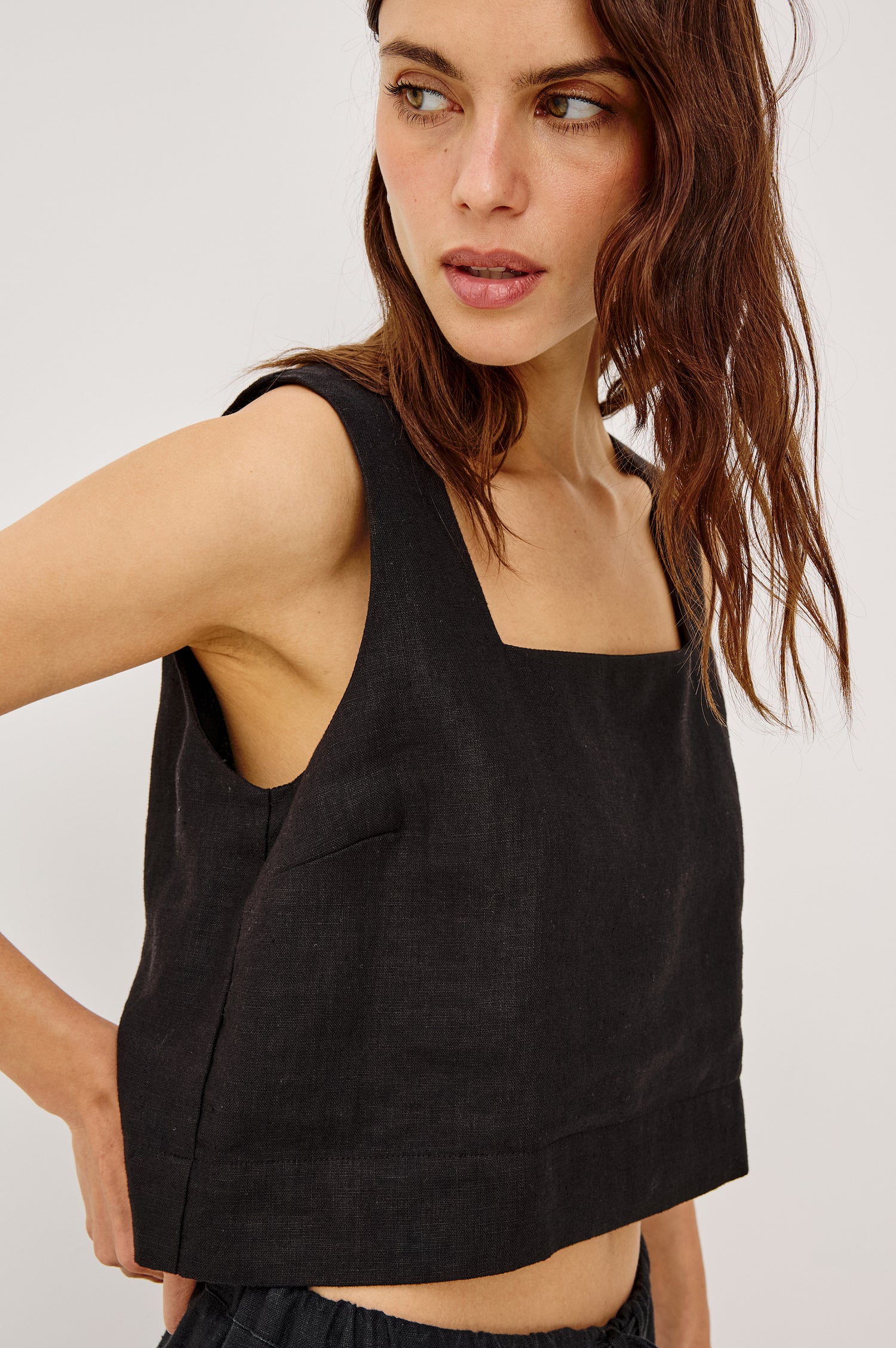 Akira Sleeveless Crop Top with Square Neckline and Wide Shoulder Straps in black Colorway - Front View Featured on Model