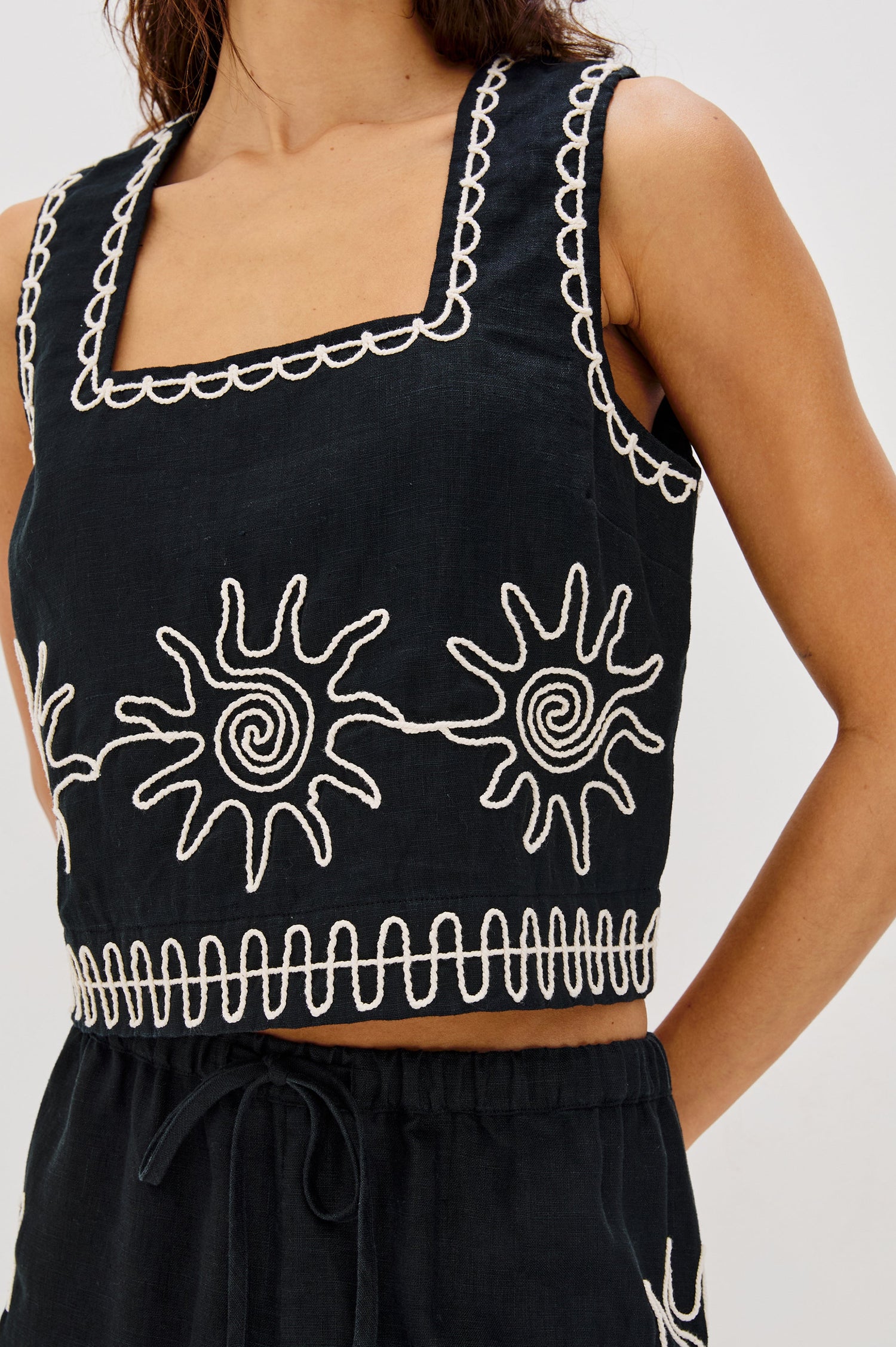 Akira Square Neck Crop Top with Wide Straps in White Contrast Sun Embroidery Colorway. Front Detailed View Shown on Model.