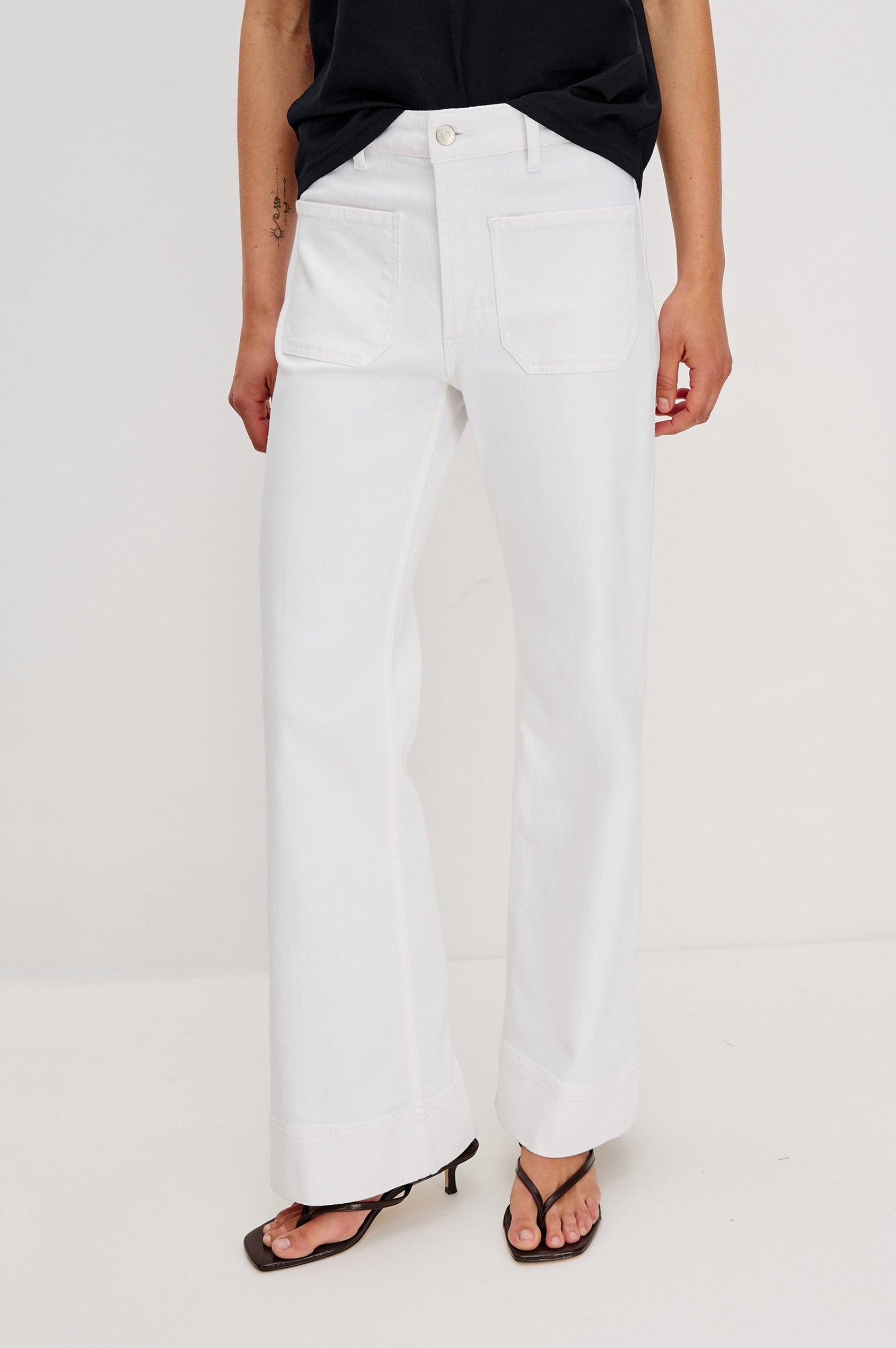 Alamitos Flared Denim Pant with Front Patch Pockets, Belt Loops and Zipper Button Fly in Salt White Colorway. Front View Shown on Model.
