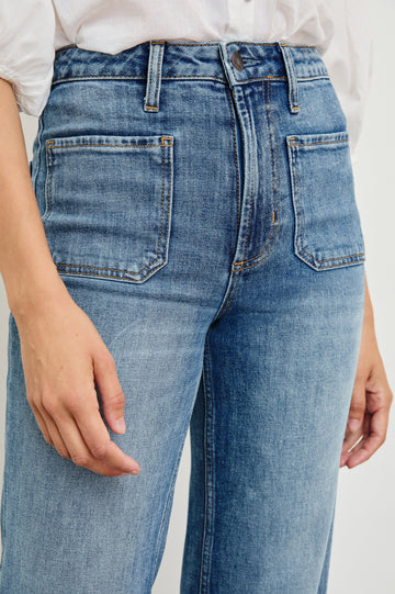 Alamitos high waisted denim trouser with flared leg and front patch pockets in Tradewind - close up of pocket details on model