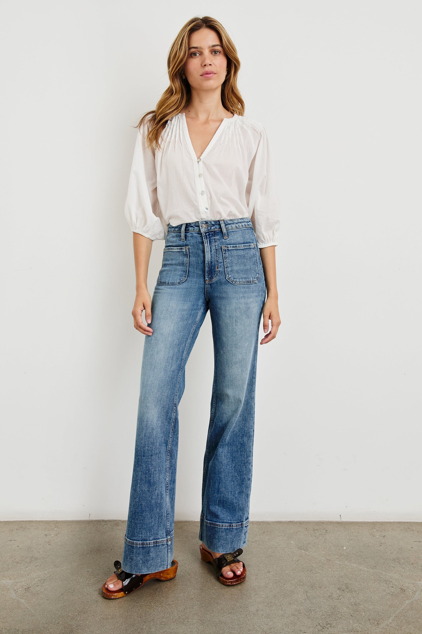 Alamitos high waisted denim trouser with flared leg and front patch pockets in Tradewind - full body front view on model