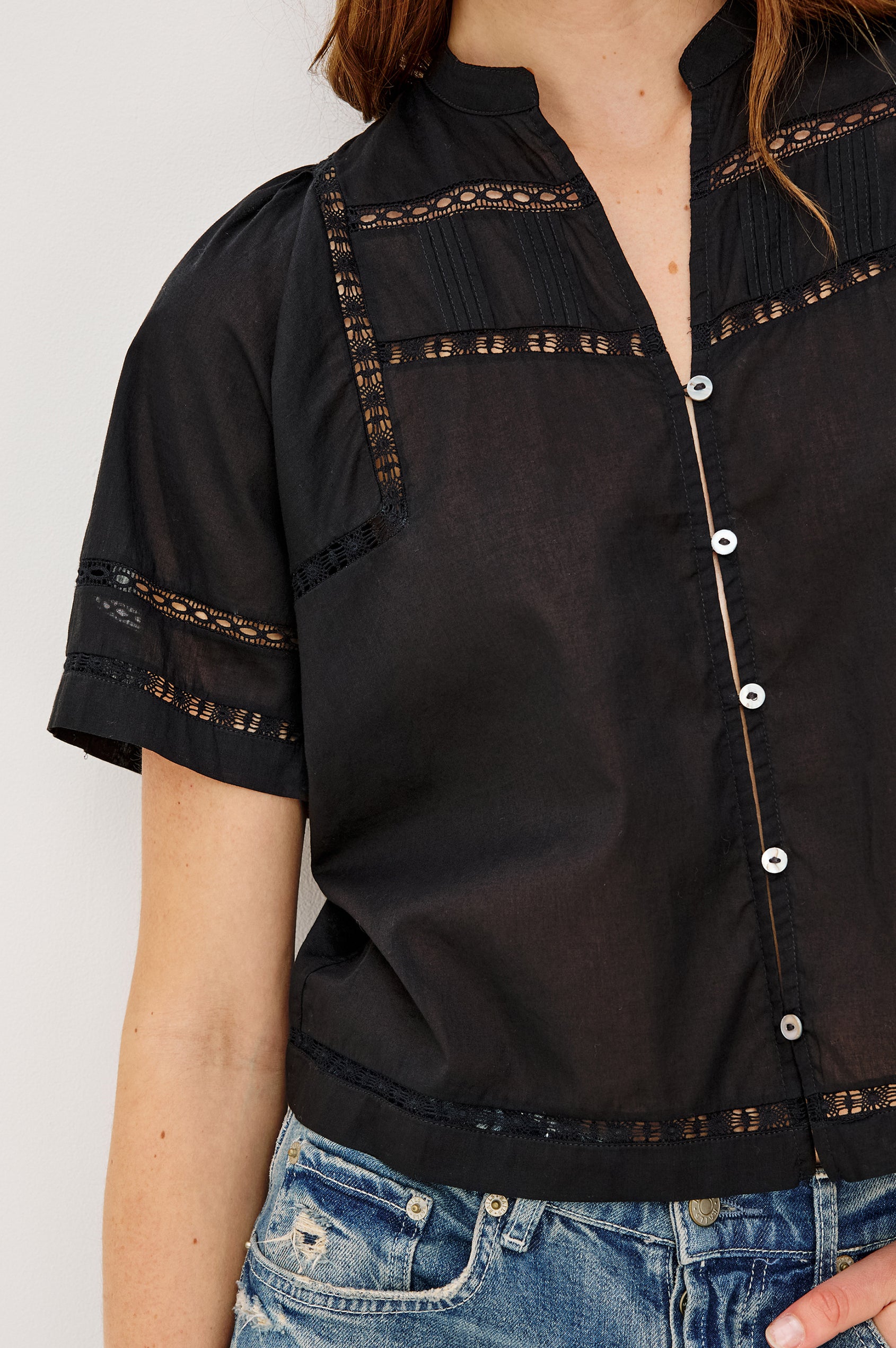 Alanis Shirt in Lightweight Cotton With Split Band V-Neckline, Front Button-and-Loop Closures, Lattice Embroidery, and Short Puff Sleeves in Black Colorway - Upper Body Front View Featured on Model