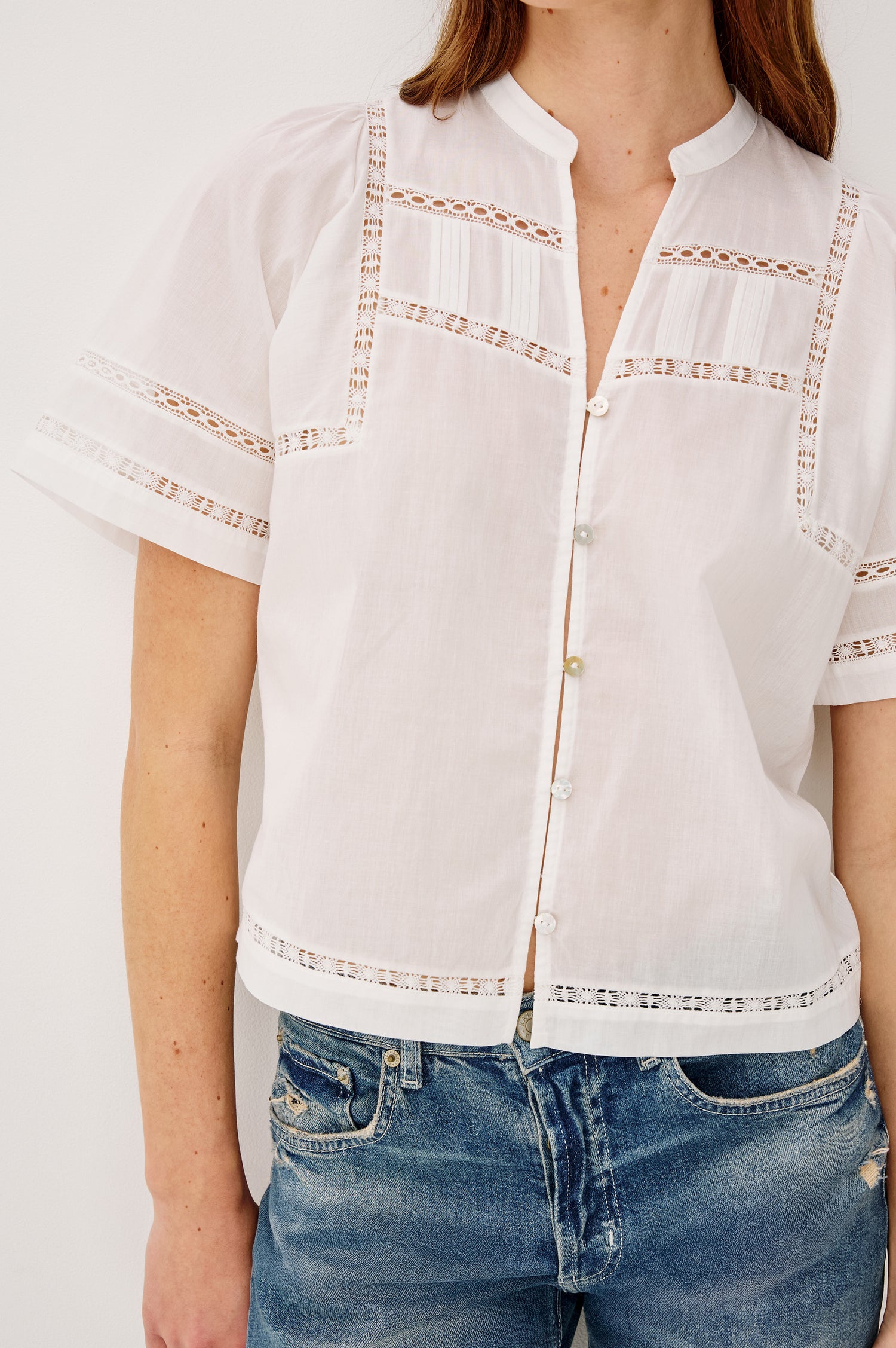 Alanis Shirt in Lightweight Cotton With Split Band V-Neckline, Front Button-and-Loop Closures, Lattice Embroidery, and Short Puff Sleeves in White Colorway - Upper Body Front View Featured on Model