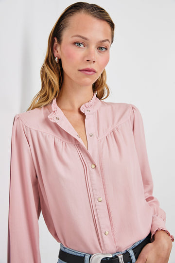 Alanna Long Sleeve Shirt with Snaps Down the Front, a Ruffled Collar, Banded Ruffed Cuffs, and Pleats at the Yoke Seam in Dusty Rose Colorway - Front Tucked View Featured on Model
