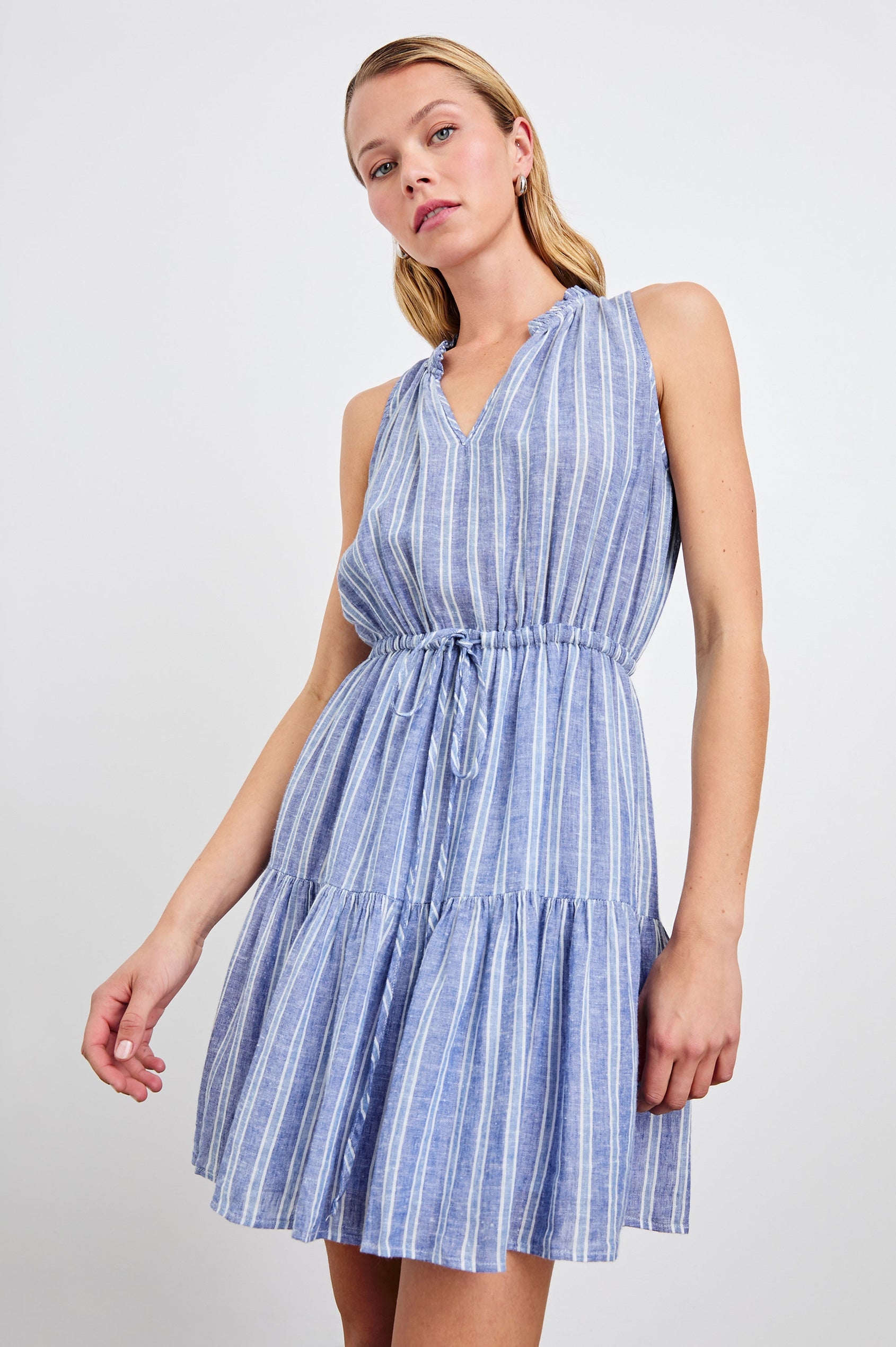 Albany Sleeveless, Mid-Thigh Dress with A Shirred Collar, Drawstring at Waist and a Pleated Hem in Lake View Stripe Colorway, Vertical stripes in blues and white - Front View Featured on Model
