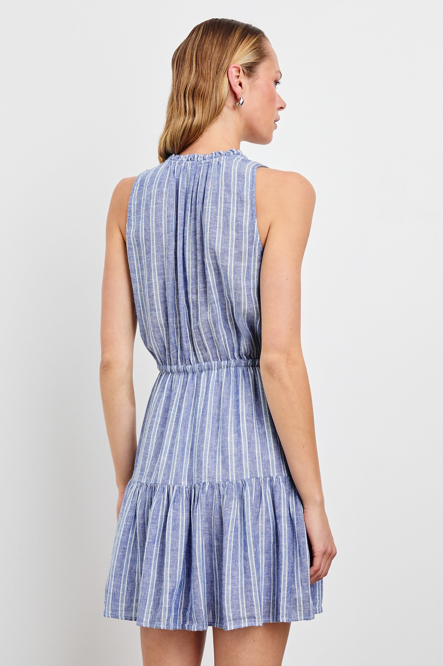 Albany Sleeveless, Mid-Thigh Dress with A Shirred Collar, Drawstring at Waist and a Pleated Hem in Lake View Stripe Colorway, Vertical stripes in blues and white - Back View Featured on Model