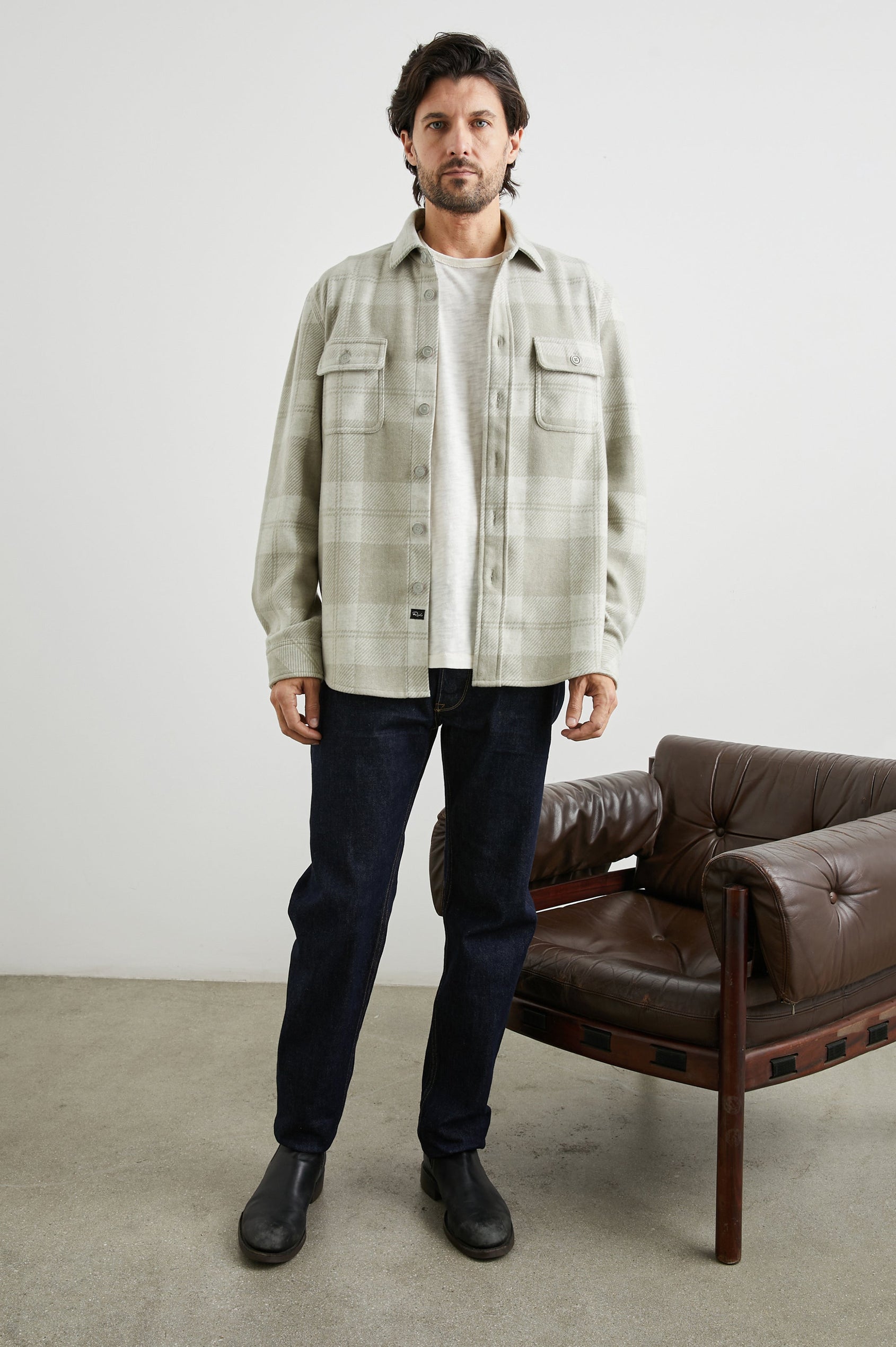 Alder Long-Sleeve Button up with Two Buttoned Chest Flap Pockets in Fawn Cream Colorway, a plaid - Front Unbuttoned Full Body View Featured on Model