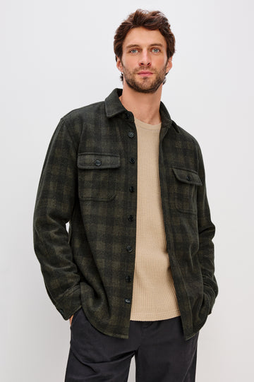 Alder Button Front Plaid Shirt in Brushed Stretch Cotton Blend With Collar, Buttoned Flap Chest Pockets, and Long Sleeves in Onyx Surplus Green Black Colorway - Full Body Front View Featured on Model