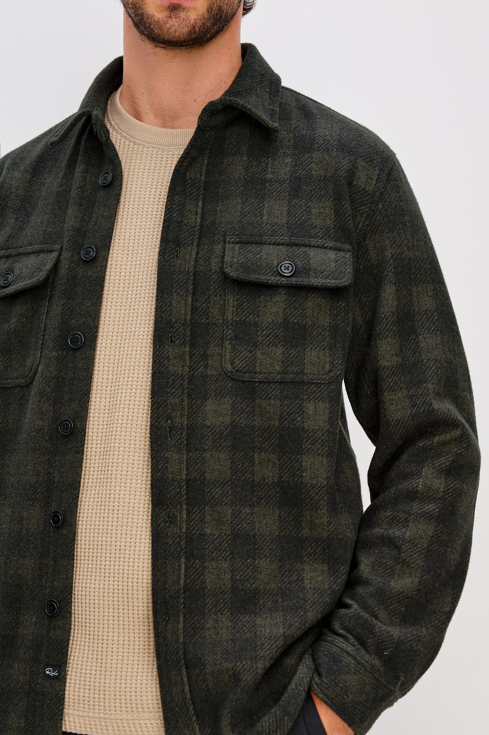 Alder Button Front Plaid Shirt in Brushed Stretch Cotton Blend With Collar, Buttoned Flap Chest Pockets, and Long Sleeves in Onyx Surplus Green Black Colorway - Upper Body Front Close Up View Featured on Model