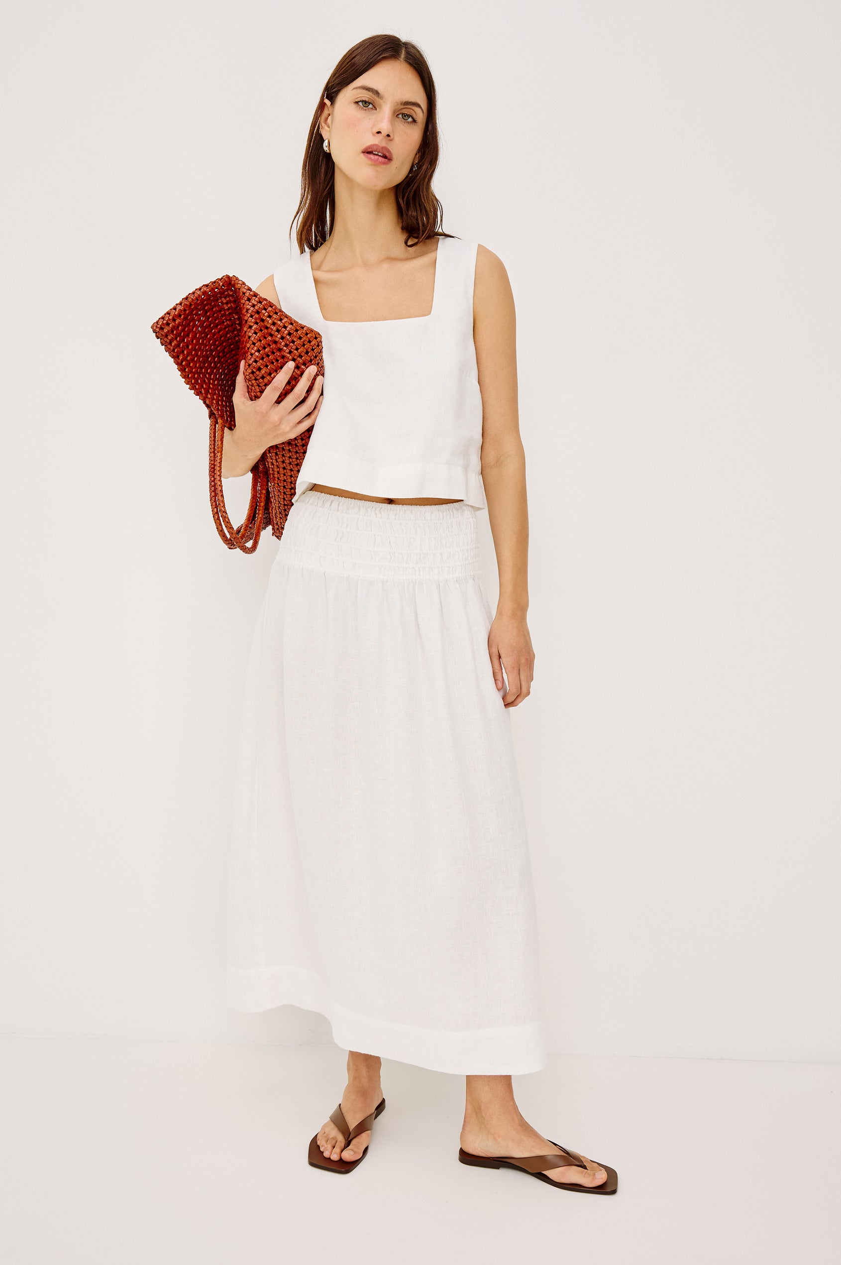 Alessa Midi Skirt in Heavy Linen With Wide Smocked Waistband and A-Line Silhouette in White Colorway - Full Body Front View Featured on Model