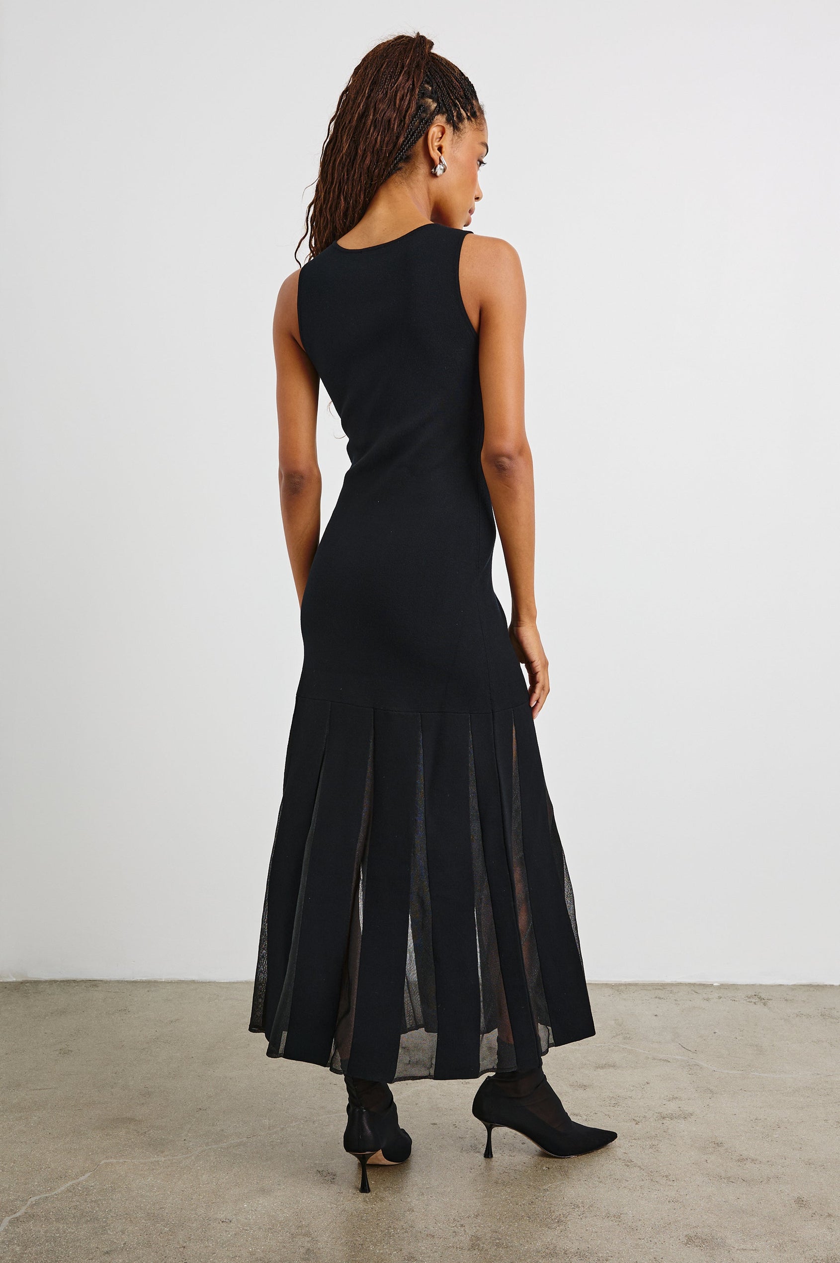 Alessia Sleeveless Maxi Dress with a Crew Neck and Sheer Vertical Inserts along the Hem from the Mid-Thigh in Black Colorway - Back Full Body View Featured on Model 
