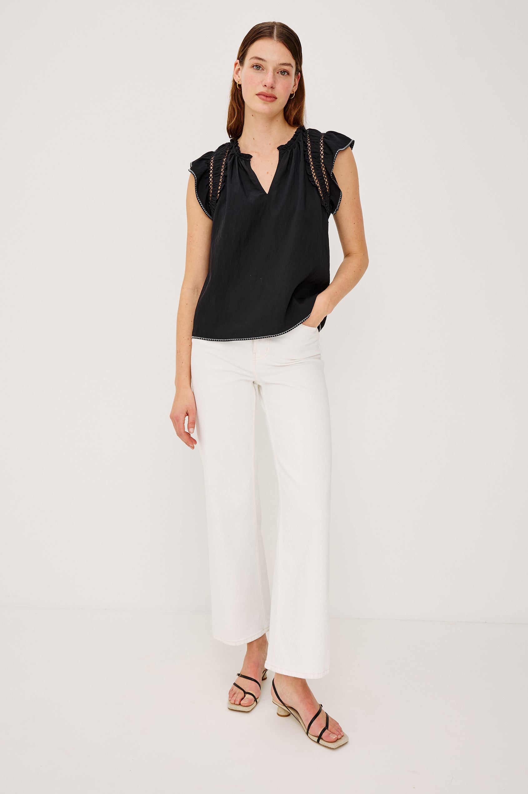 Allea Top in Poplin With Relaxed Fit Split V-Neck. Flutter Sleeves With Contrast Stitcing and Lattice Cutwork in Black Colorway - Upper Body Front View Featured on Model