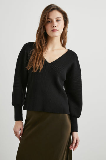 Alondra Ribbed Long-Sleeve Sweater with a Deep V Neck and Puff Sleeves in Black Colorway - Front View Featured on Model 