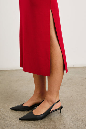 Alora Sleeveless Midi Dress with a Shallow Boat Neck, Mid-Thigh Side Slit, and a Fine Rib Knit in Cherry Colorway - Side View Featured on Model