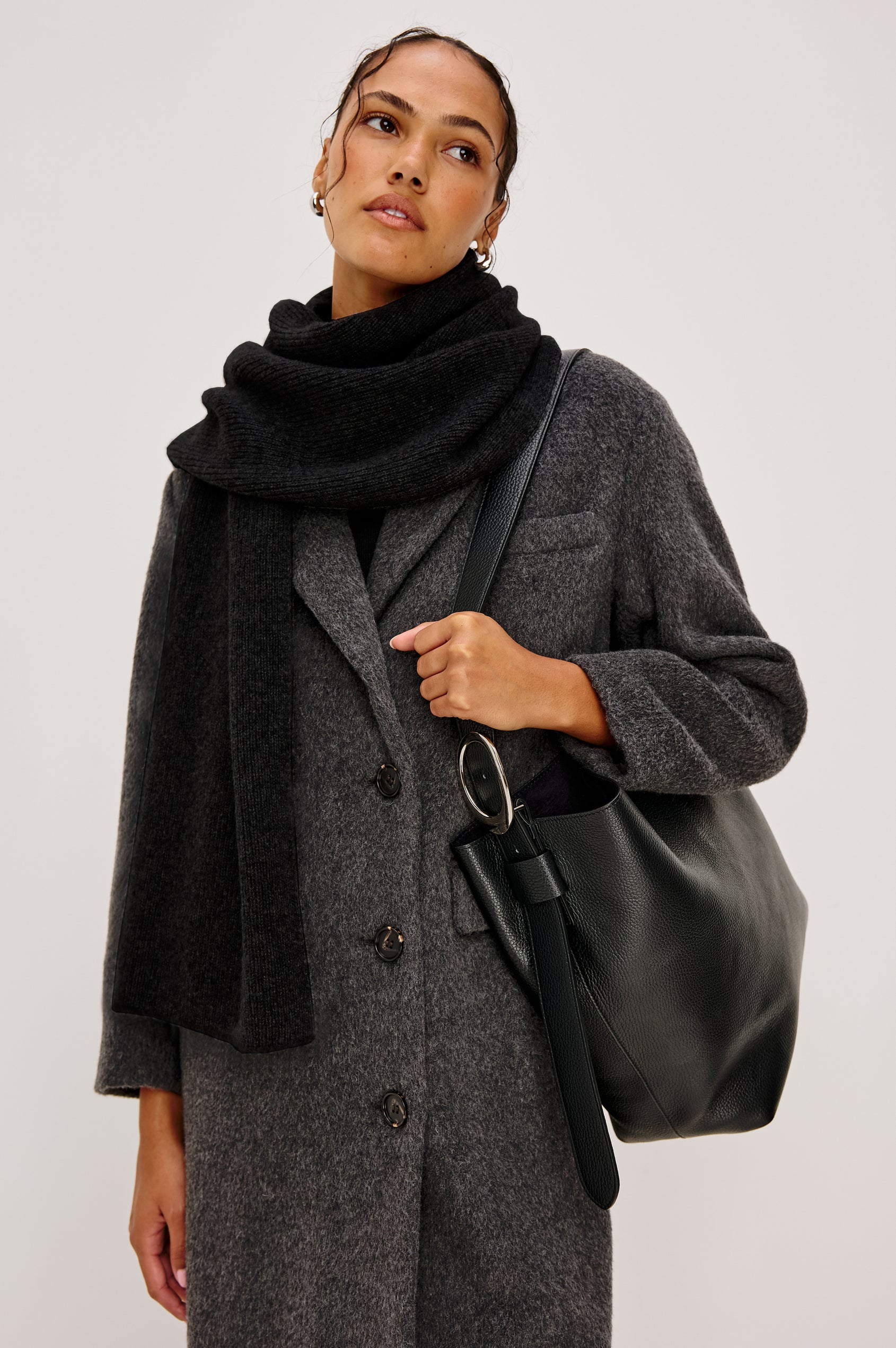 Alps knitted cashmere blend scarf in Black coloraway. Front view featured on model.