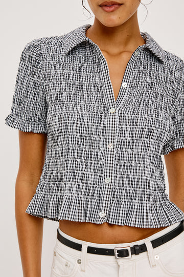 Alton Top in Cotton Poplin With Smocked Body Boxy Cropped Fit Collar Front Buttons Short Puff Sleeves and Ruffle Trim in Black Gingham Colorway - Upper Body Close Up Front View Featured on Model