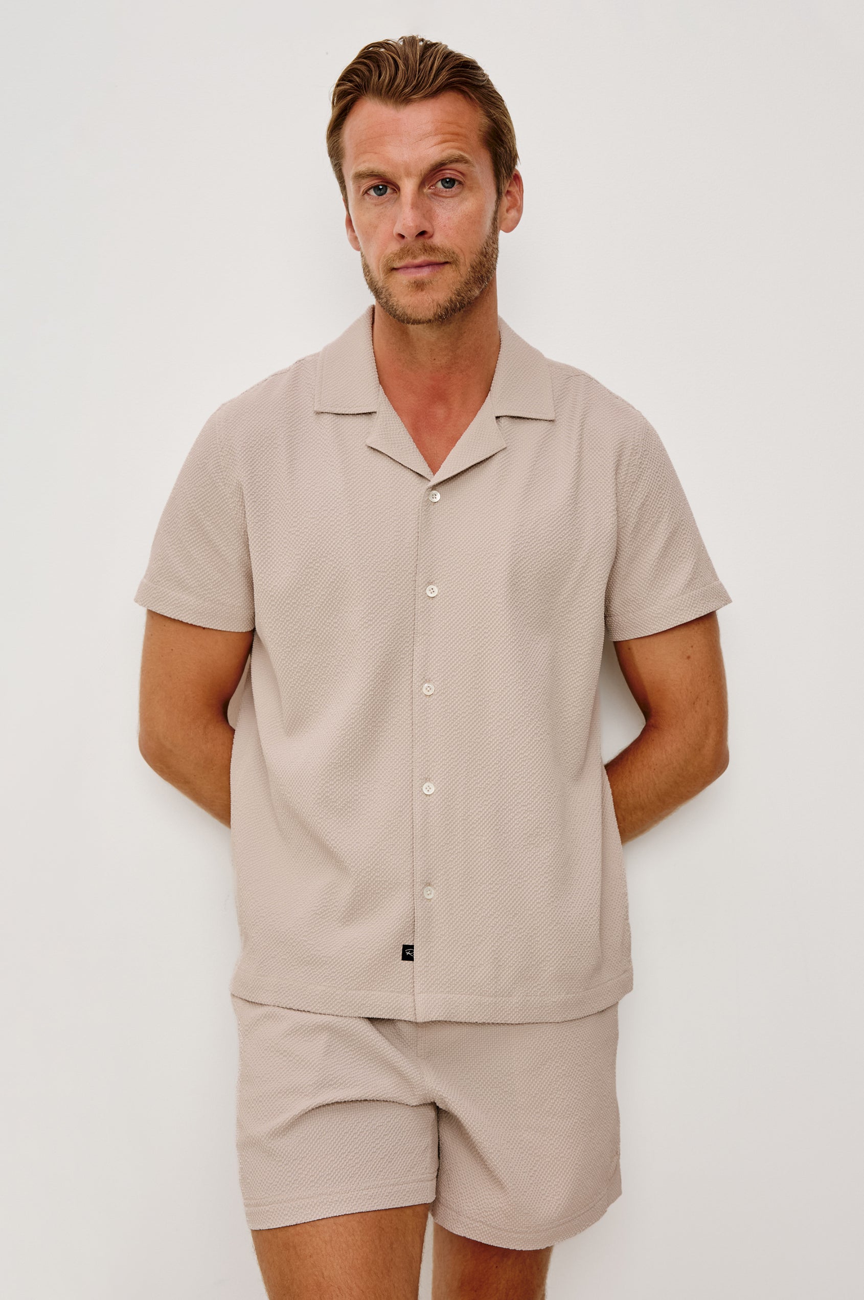 La Brea Swim Short in Stretch Polyester Seersucker With Adjustable Drawstring Waist Ties in Khaki Check Seersucker Colorway - Upper Body Front View Featured on Model