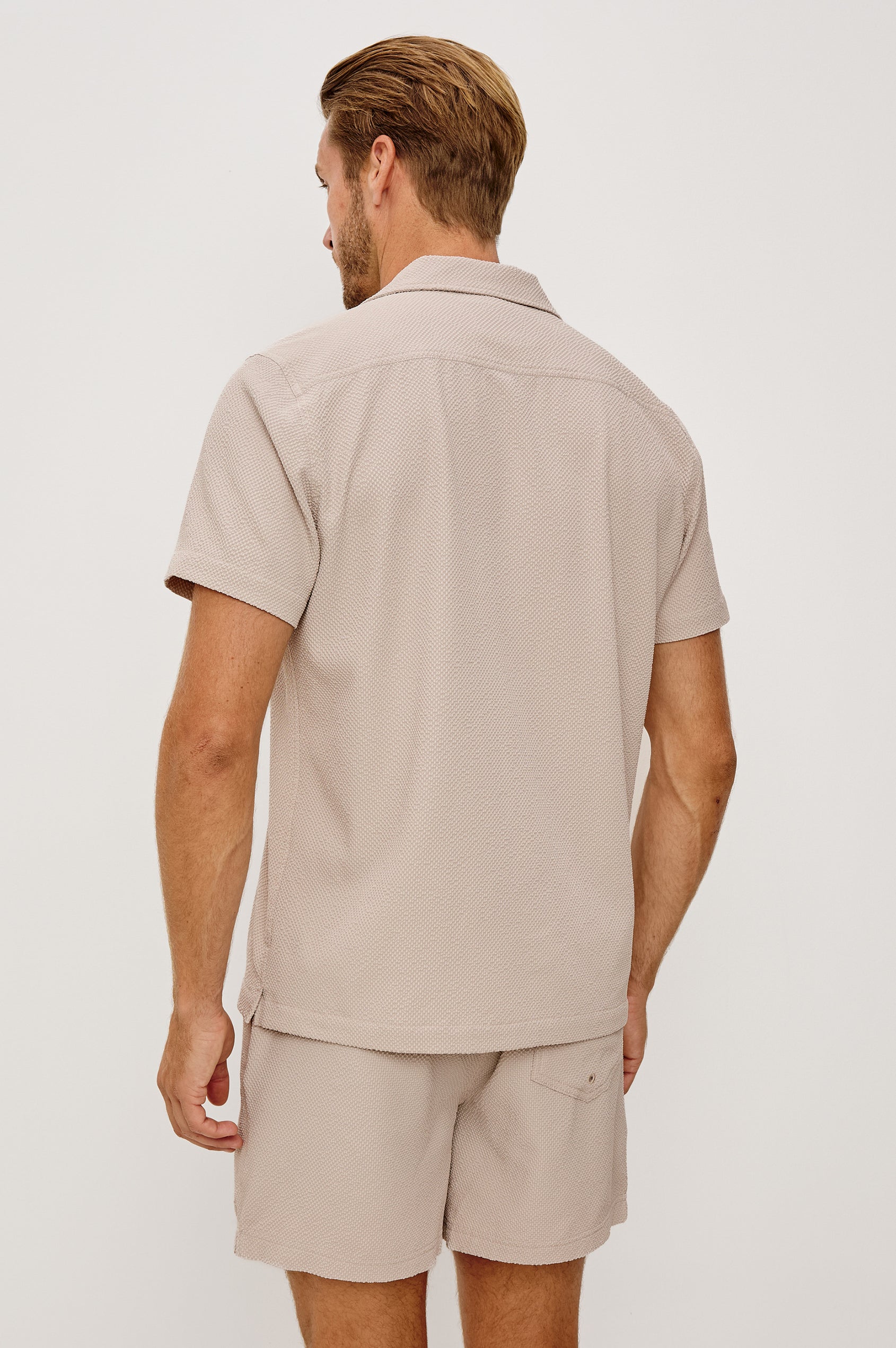 La Brea Swim Short in Stretch Polyester Seersucker With Adjustable Drawstring Waist Ties in Khaki Check Seersucker Colorway - Upper Body Back View Featured on Model