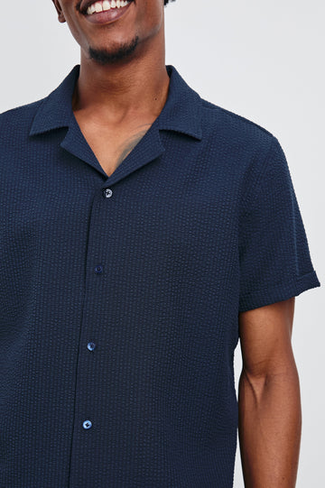 Amalfi Short-Sleeve Button Up in Navy Seersucker Colorway - Front View Featured on Model