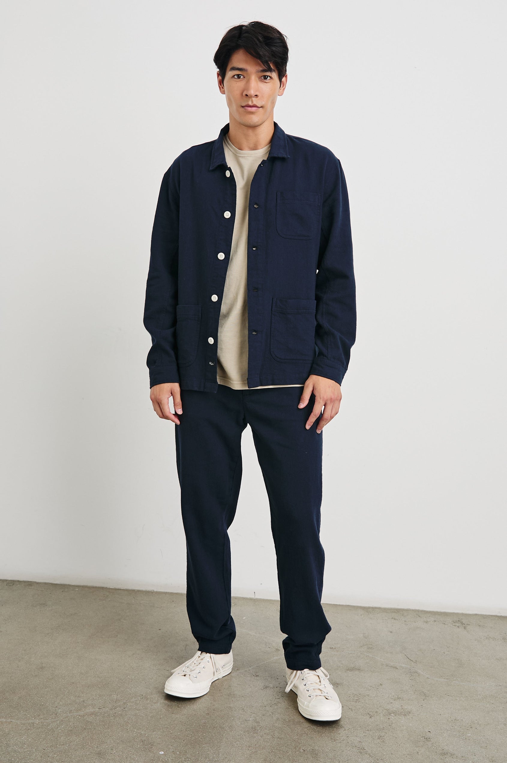 Ambrose Jacket with Button Closure and Two Front Patch Pockets and a Chest Patch Pocket in Deep Meridian Colorway - Front Full Body View Featured on Model