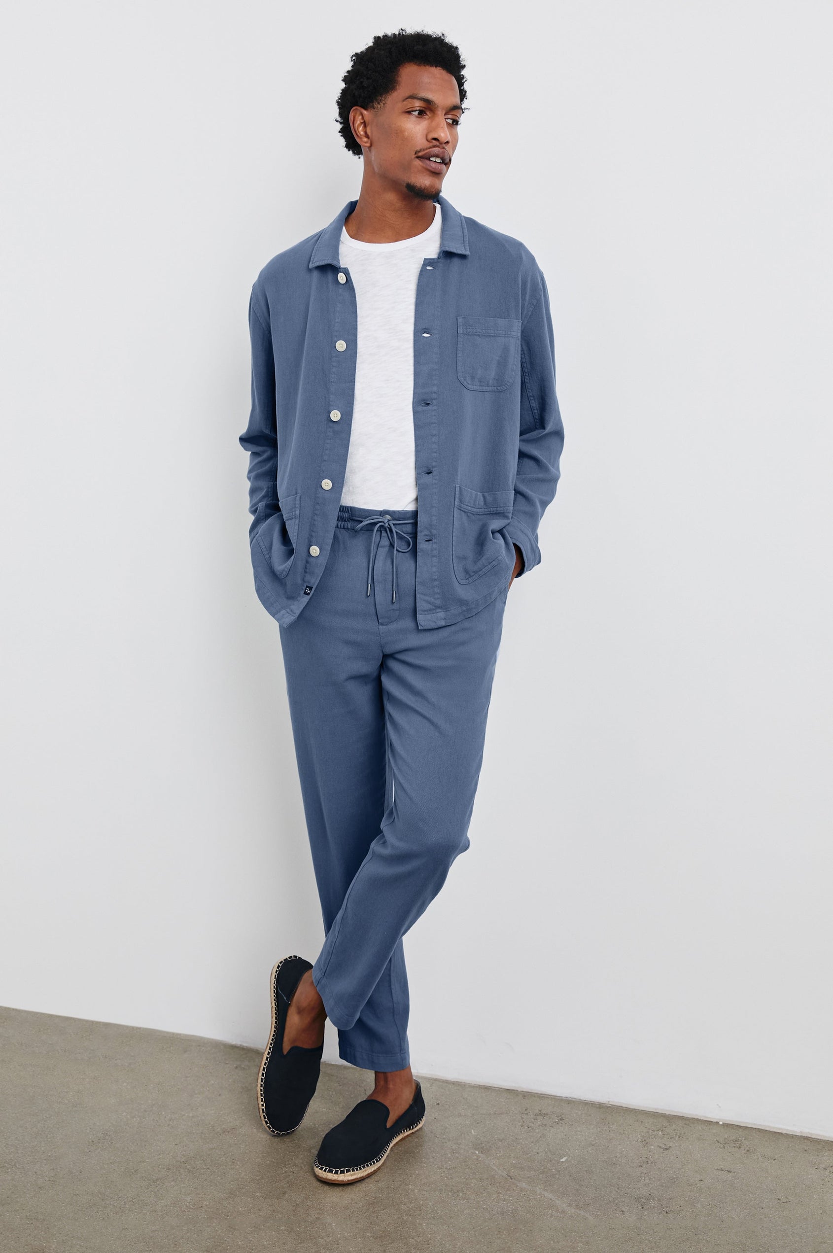 Ambrose Jacket with Button Closure, Tow Front Patch Pockets and a Chest Patch Pocket in Washed Blue Colorway - Front Full Body View Featured on Model