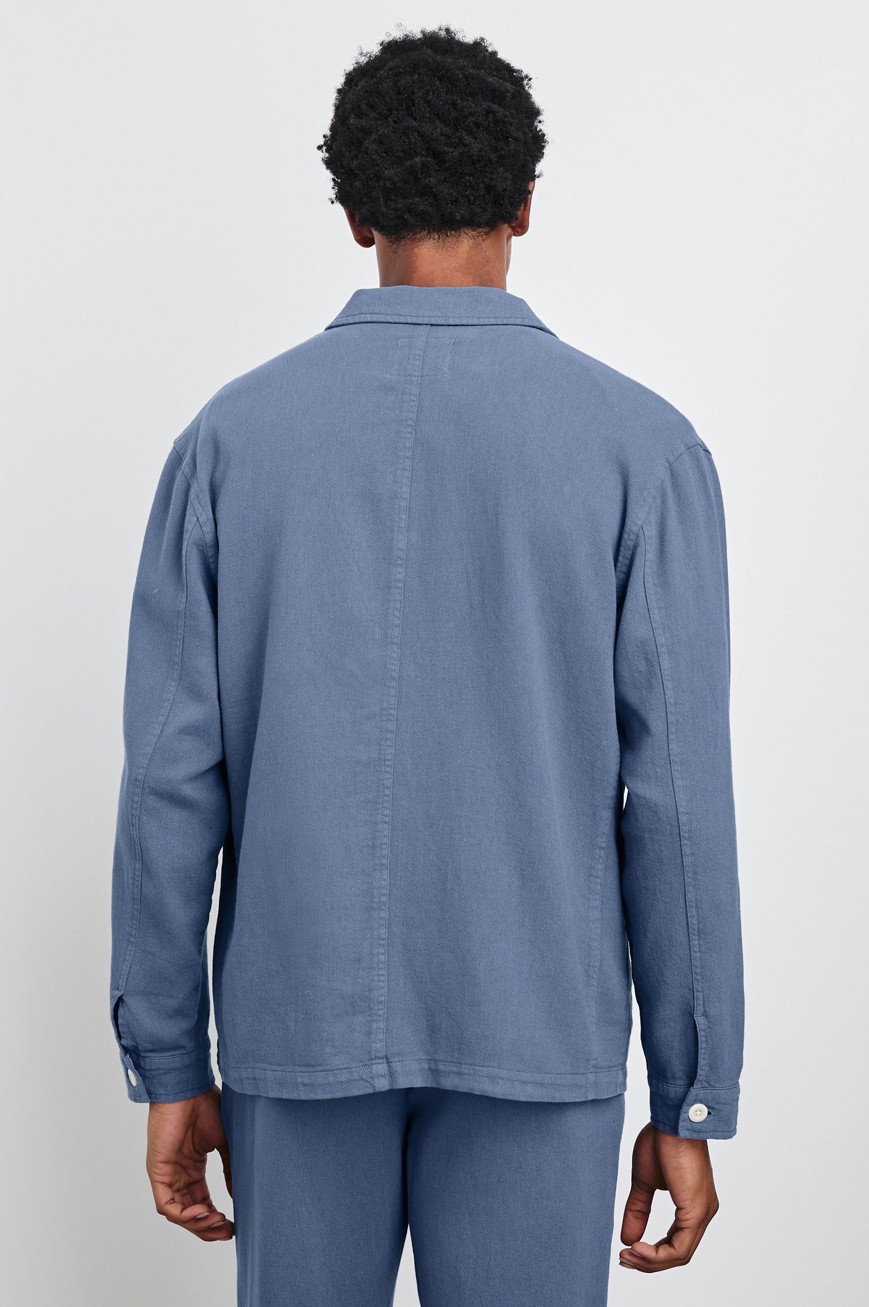 Ambrose Jacket with Button Closure, Tow Front Patch Pockets and a Chest Patch Pocket in Washed Blue Colorway - Back View Featured on Model