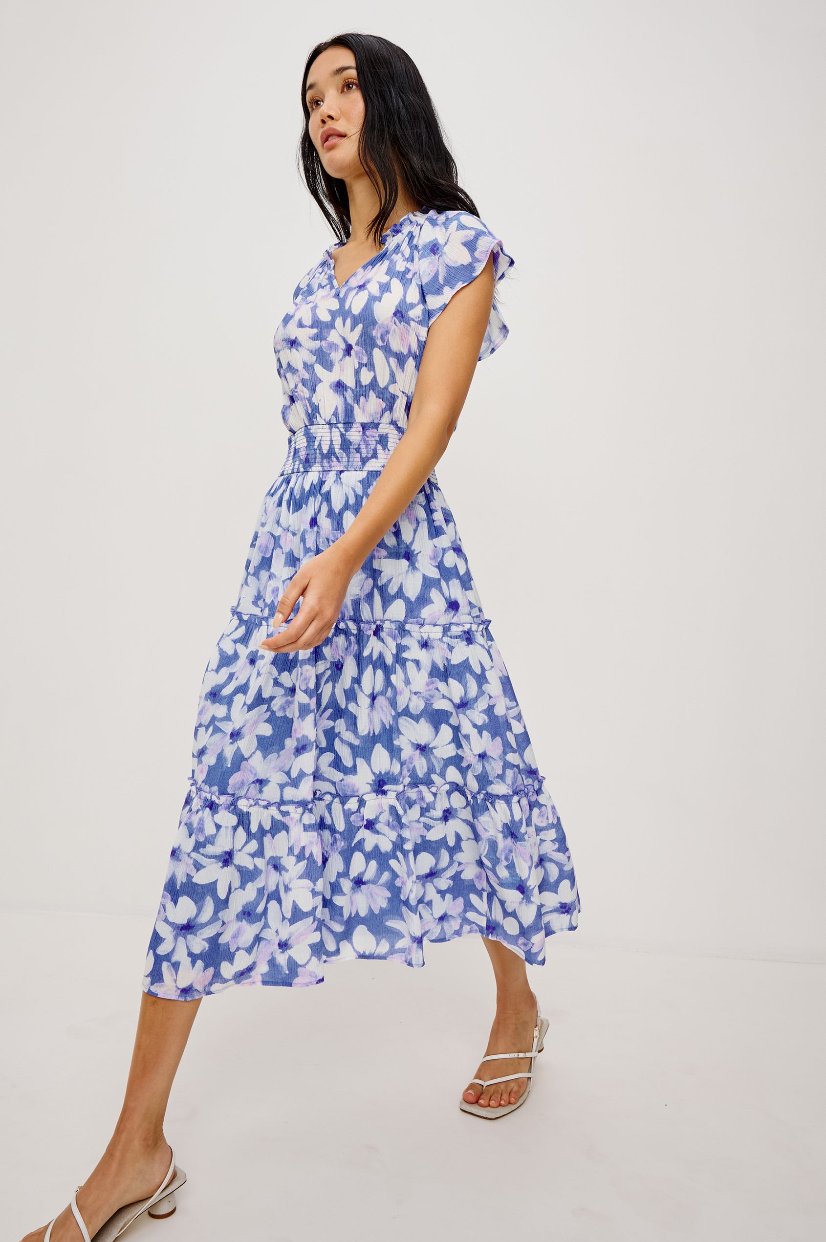Amellia Midi Dress in Chiffon With Ruffled Split V-Neckline Flutter Sleeves a Smocked Waist and Tiered A-Line Skirt in Blue Ameranth Colorway - Full Body Front View Featured on Model