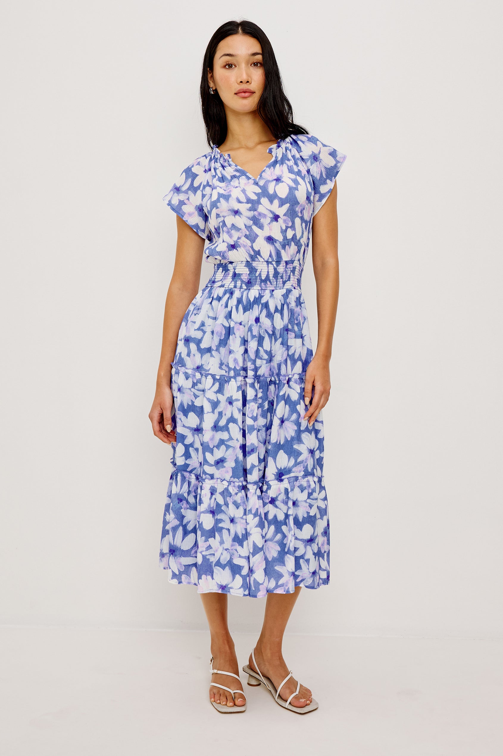 Amellia Midi Dress in Chiffon With Ruffled Split V-Neckline Flutter Sleeves a Smocked Waist and Tiered A-Line Skirt in Blue Ameranth Colorway - Full Body Front View Featured on Model