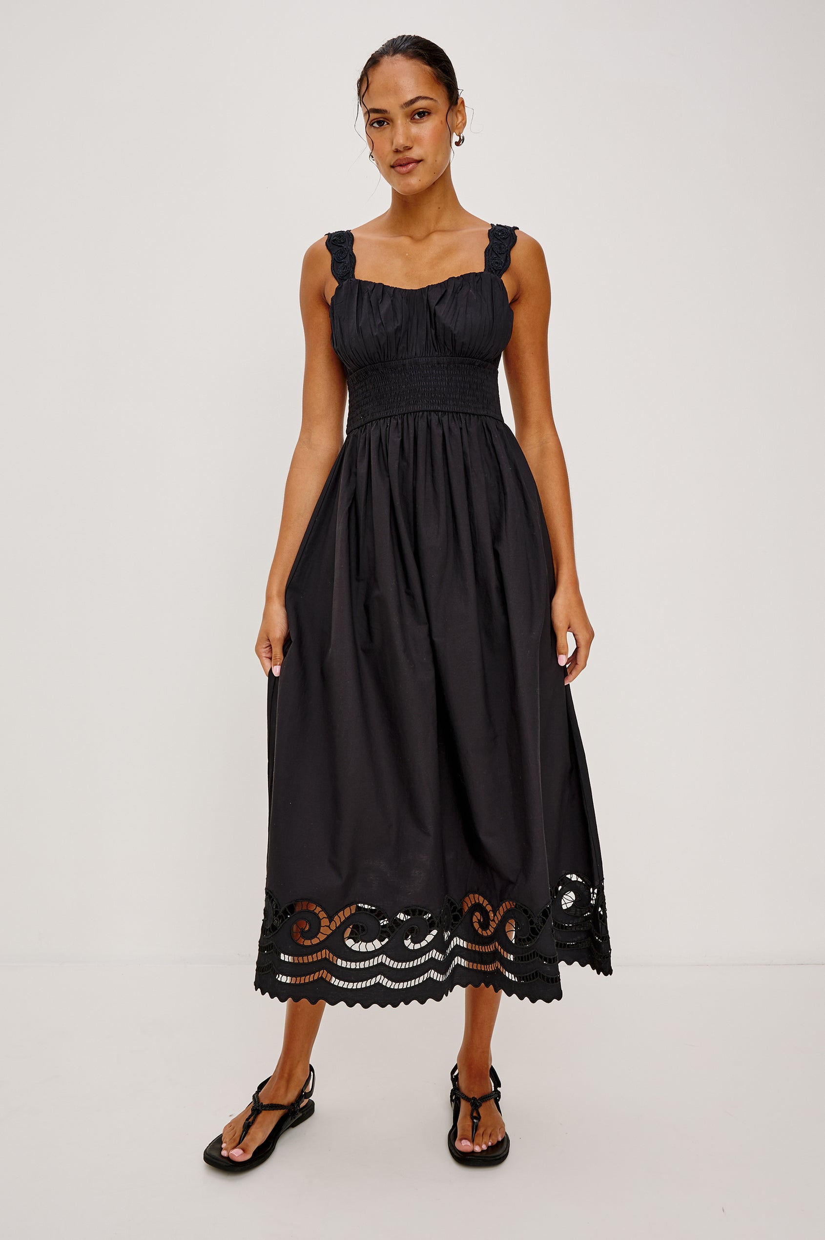 Anadia Maxi Dress in Poplin With Soutached Swirl Shoulder Straps, Ruched Bust, Smocked Empire Waist, and Scalloped Ladder Embroidered Hem in Black Colorway - Full Body Front View Featured on Model