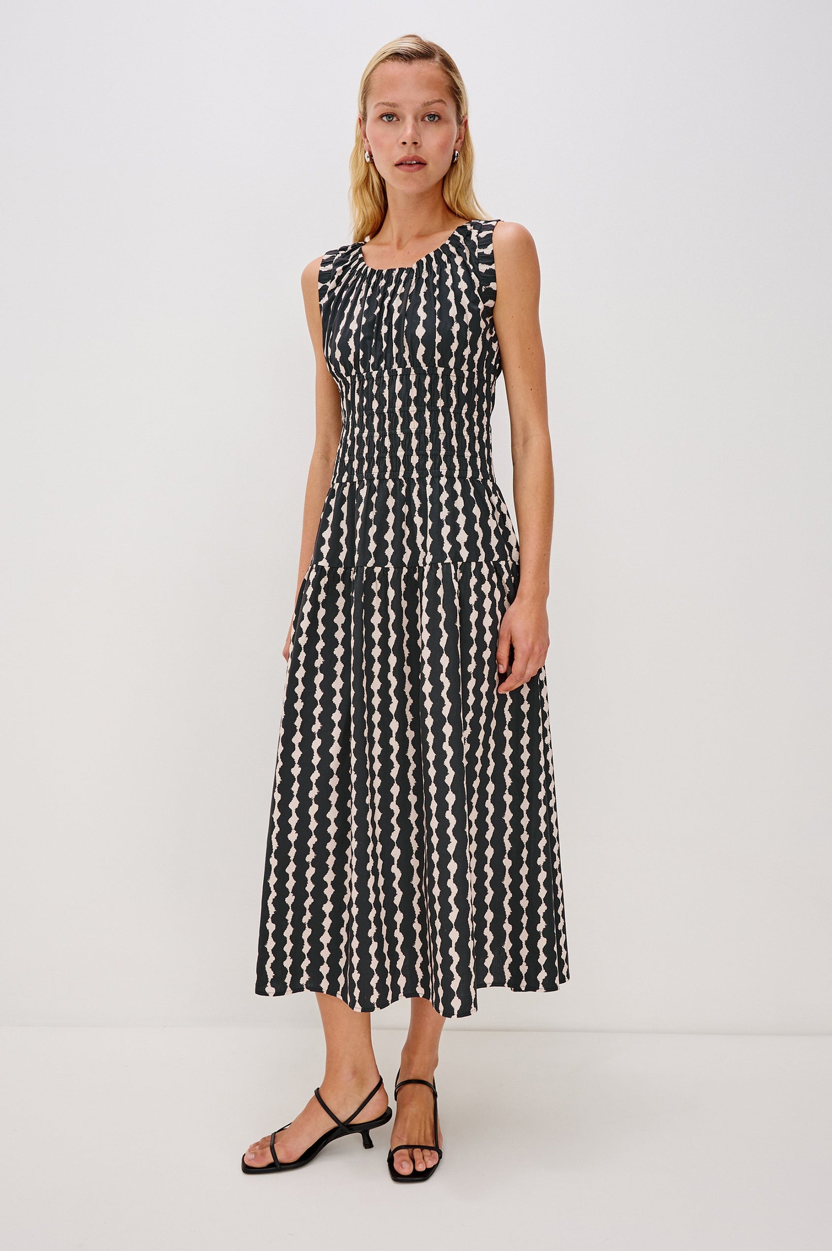 Anastasia Sleeveless Tiered Midi Dress with Shoulder Straps, a Scoop Neck and Ruching on the Bodice in Painted Noir Colorway - full body front view on model