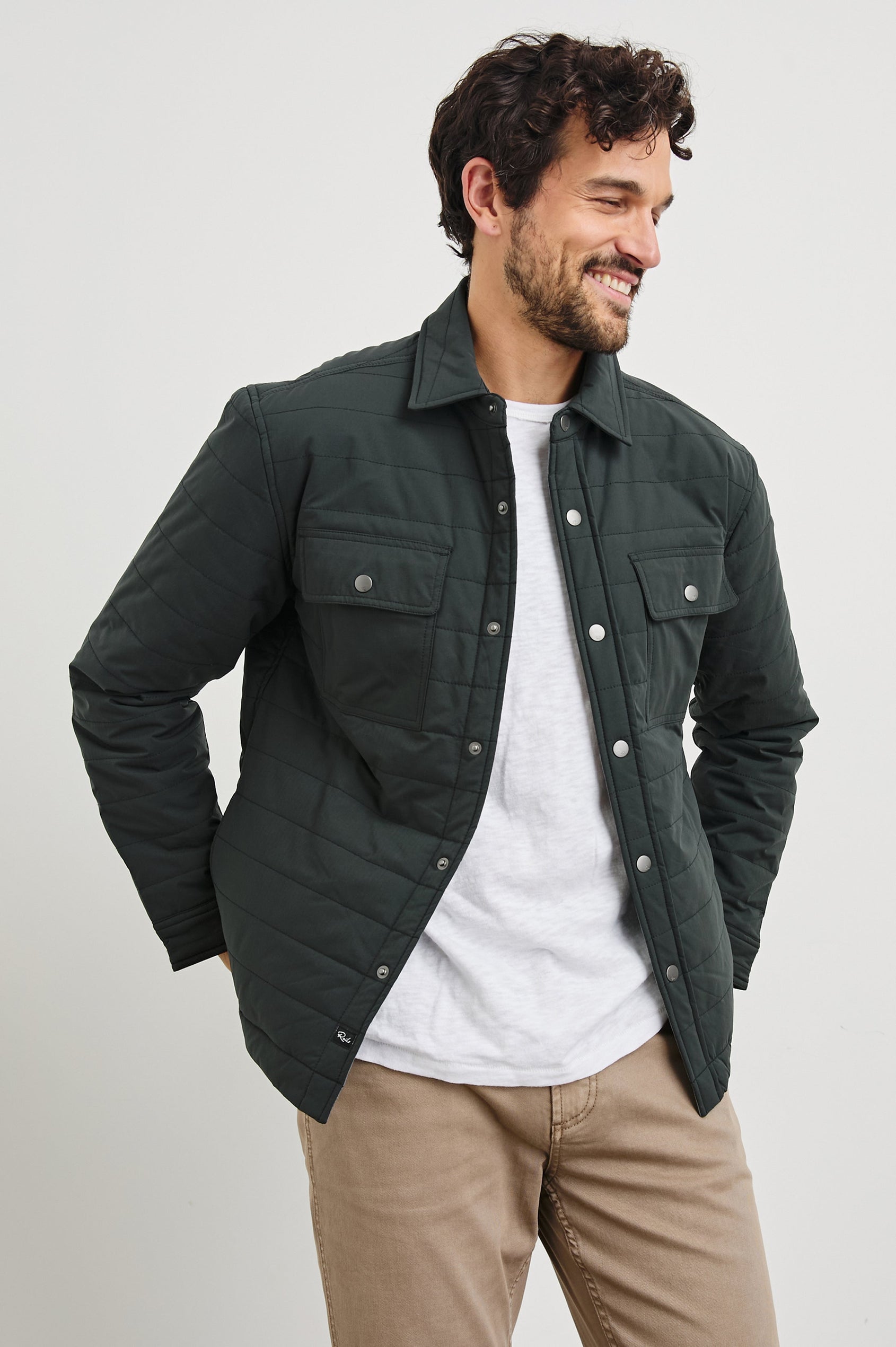 Andover Quilted Puffer Jacket with Snap Closure, Two Chest Snap Flap Pockets, and Two Front Pockets in Black Colorway - Front View Featured on Model  