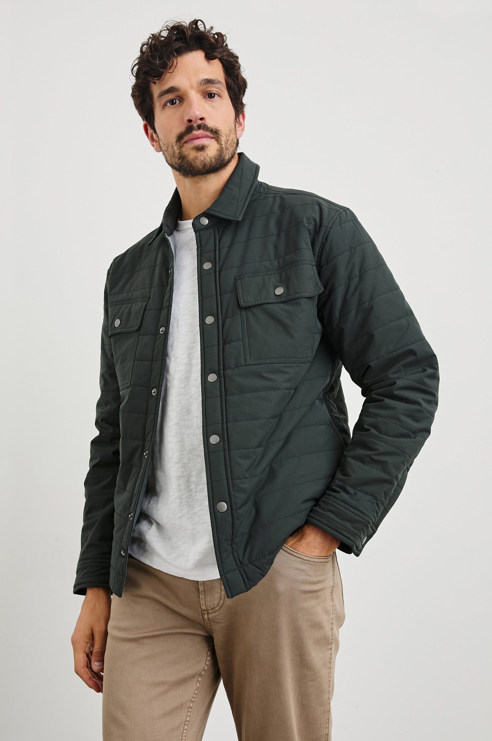 Andover Quilted Puffer Jacket with Snap Closure, Two Chest Snap Flap Pockets, and Two Front Pockets in Black Colorway - Front View Featured on Model  