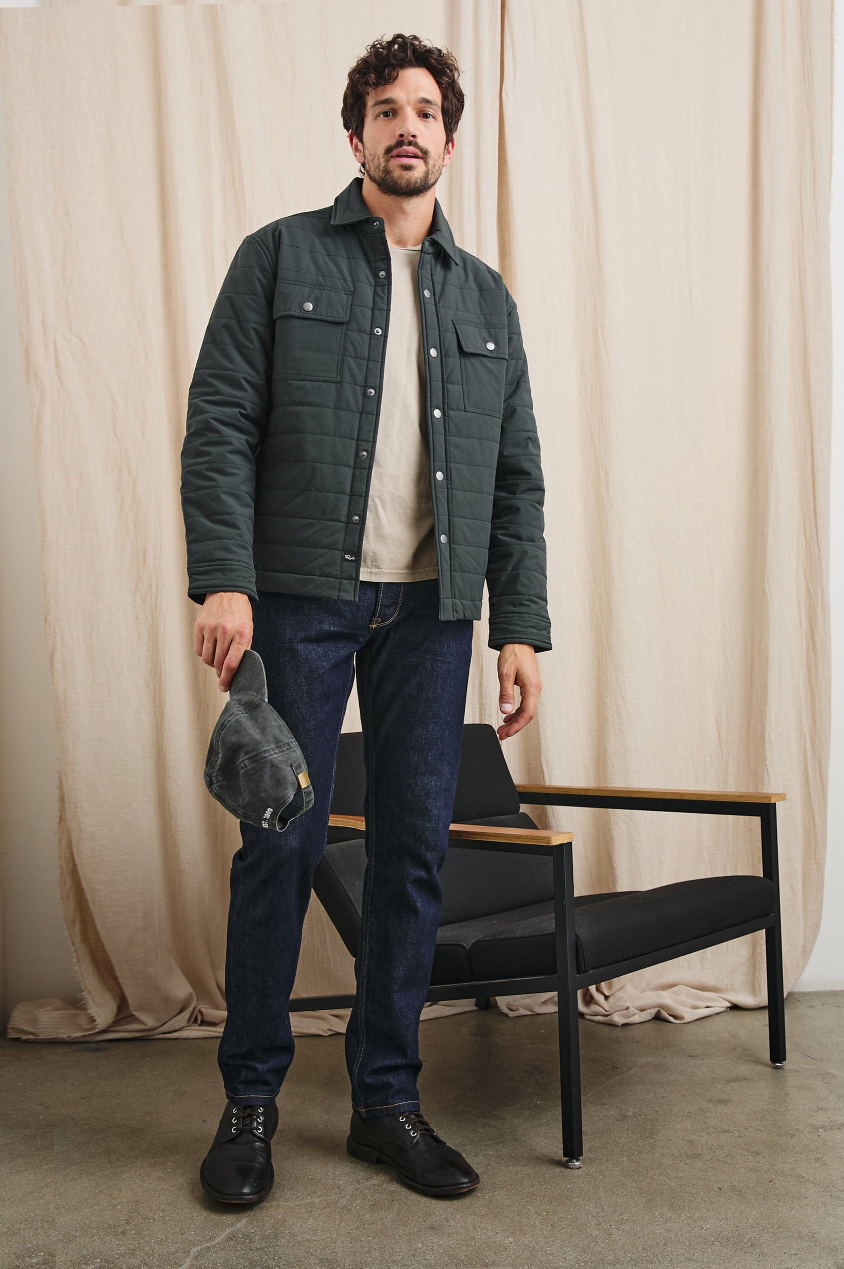 Andover Quilted Puffer Jacket with Snap Closure, Two Chest Snap Flap Pockets, and Two Front Pockets in Black Colorway - Front Full Body View Featured on Model  