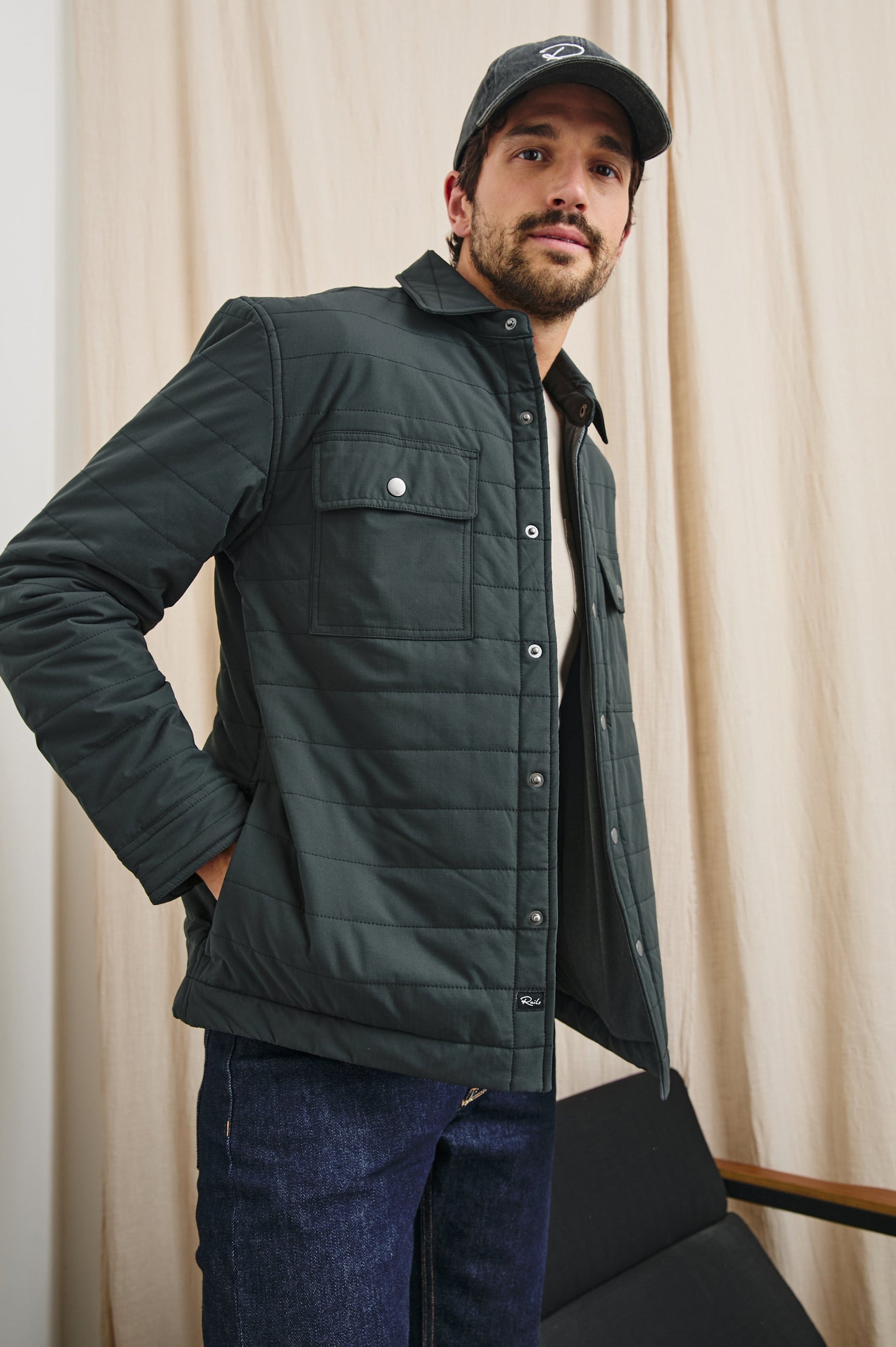 Andover Quilted Puffer Jacket with Snap Closure, Two Chest Snap Flap Pockets, and Two Front Pockets in Black Colorway - Front View Featured on Model  