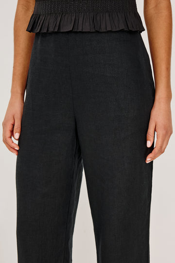 Andrine Pant in Heavy Linen With High-Waisted Fit, Straight Legs, Unlined, Side On-Seam Pockets, Side Zip Closure in Black Colorway - Lower Body Front View Featured on Model