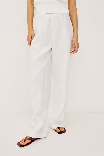Andrine Pant in Heavy Linen With High-Waisted Fit, Straight Legs, Unlined, Side On-Seam Pockets, Side Zip Closure in White Colorway - Lower Body Front View Featured on Model