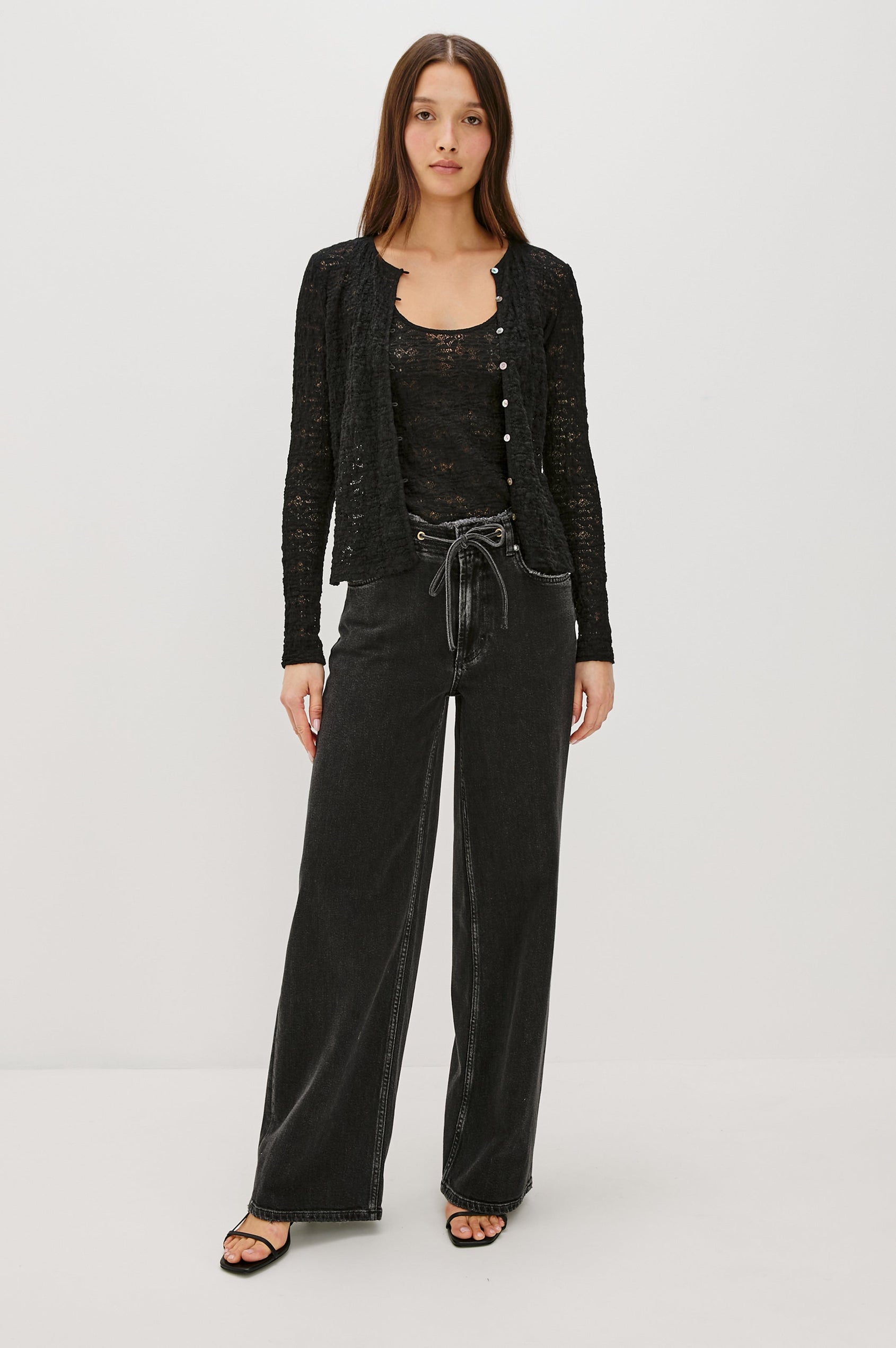 Angeleno mid rise slouchy wide leg jean with a drawstring waist tie, gromets and a raw edge waistband in a black wash Ash Black - front full body view featured on model.