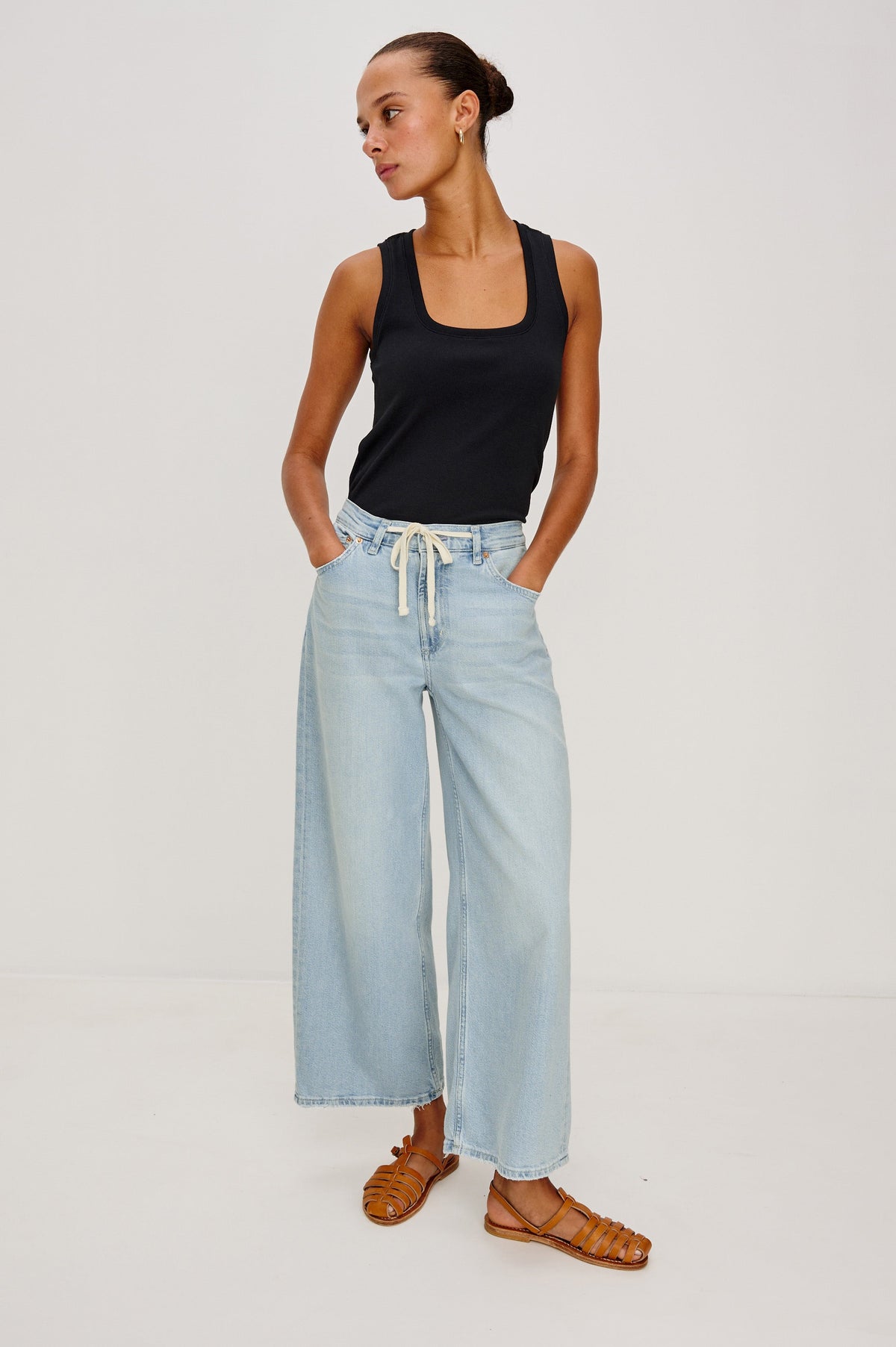 Angeleno Crop Denim Pant, Wide Leg, Five Pocket Zip Fly with a White Drawstring Tie at Waist in Light Wash Scuba Colorway. Front full body View Shown on Model.