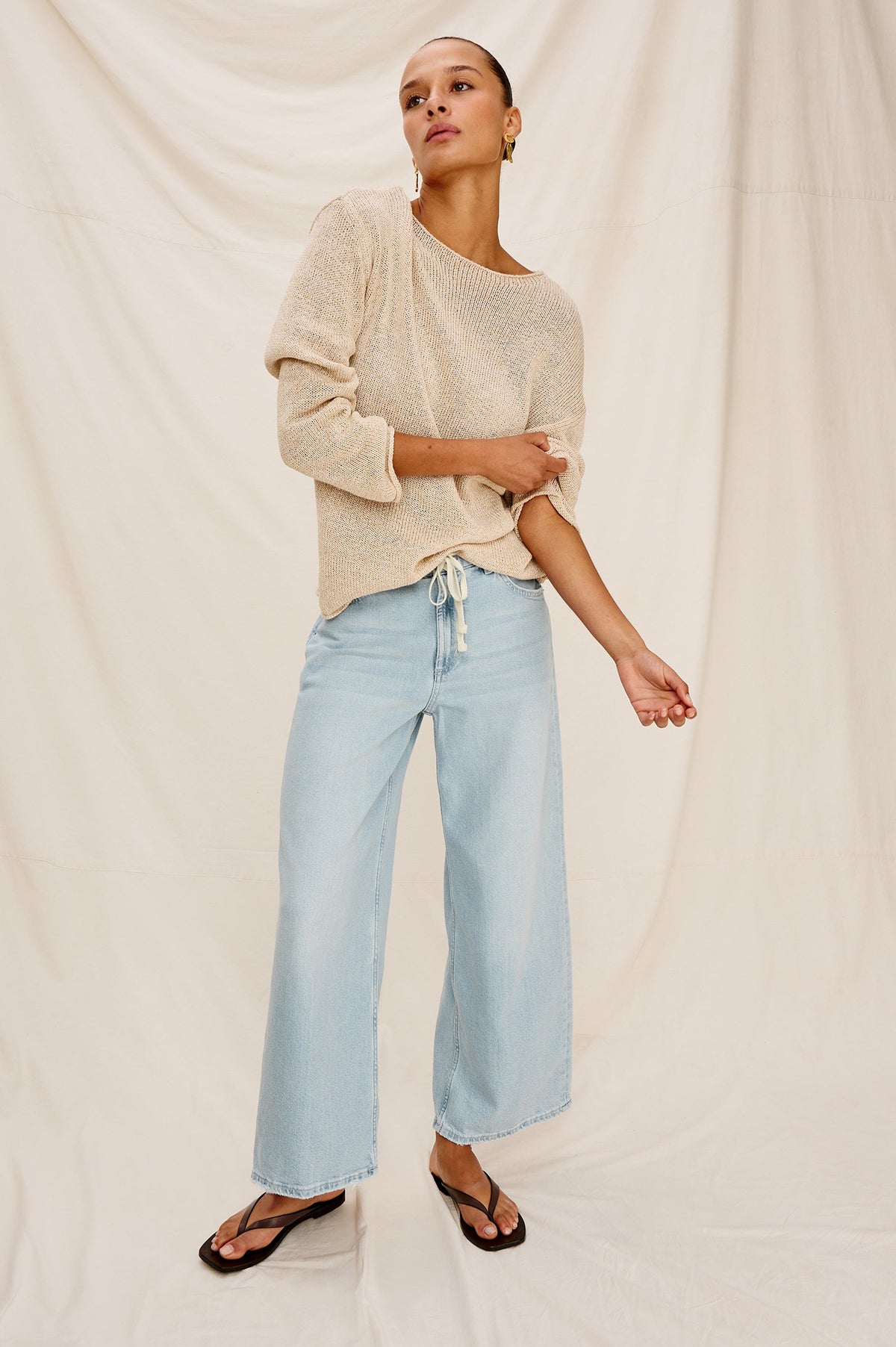 Angeleno Crop Denim Pant, Wide Leg, Five Pocket Zip Fly with a White Drawstring Tie at Waist in Light Wash Scuba Colorway. Front full body View Shown on Model.